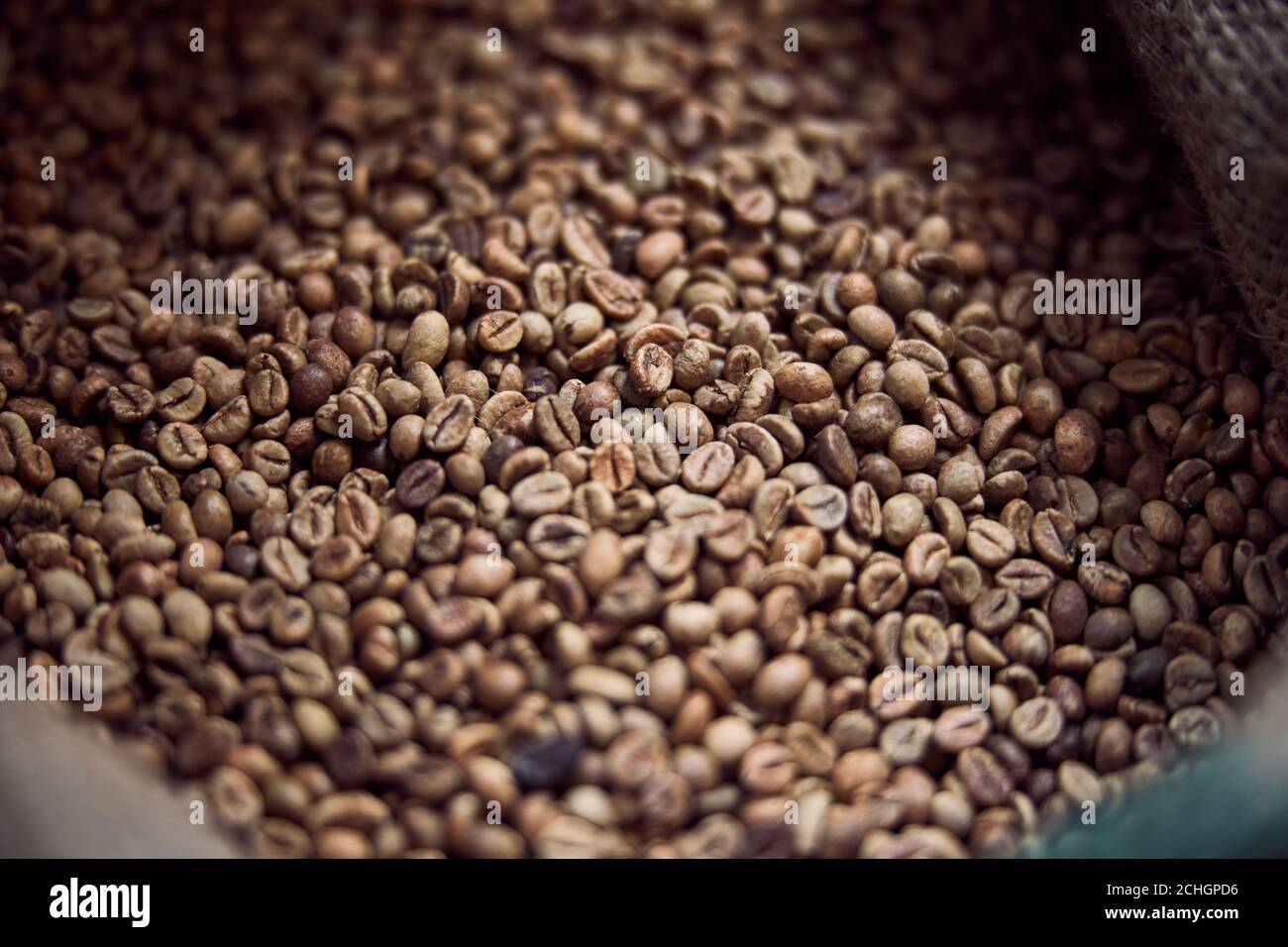 Roasted coffee beans stored in burlap sack Stock Photo Alamy