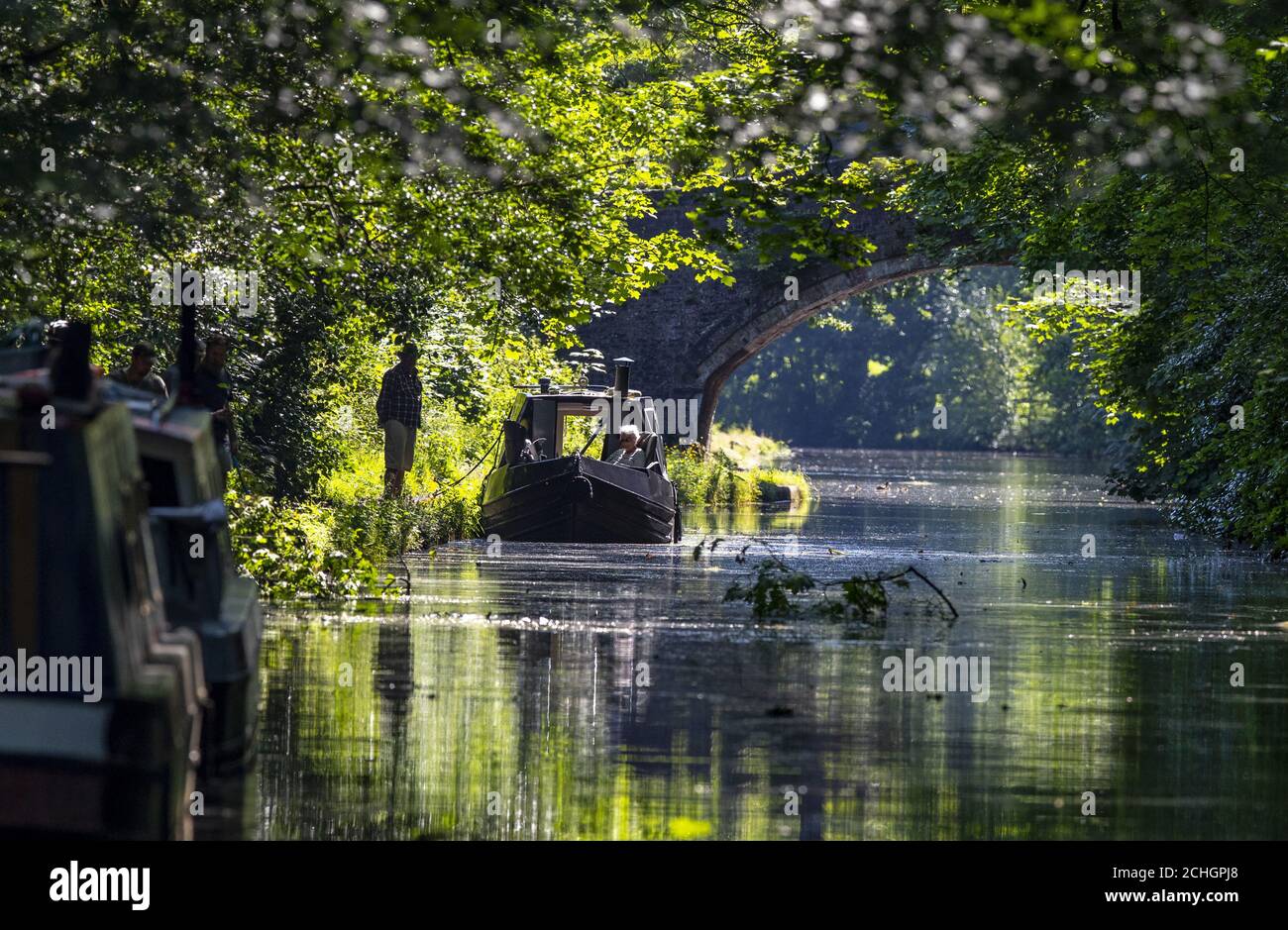 A couple enjoy the hot weather on their canal boat on Bridgewater Canal in Walton Hall, Cheshire