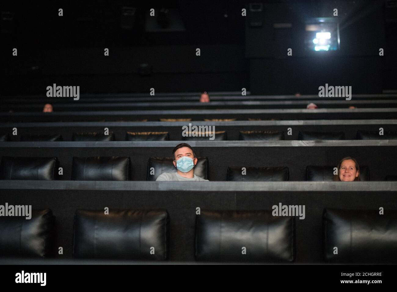 Film goers at the Showcase Cinema, Bluewater, Kent sit down, socially distanced, to watch their first film since March as it reopens following the easing of coronavirus lockdown restrictions across England. PA Photo. Picture date: Saturday July 4, 2020. The easing of restrictions, which were imposed on March 23, allows businesses including pubs restaurants and hair salons, to reopen to members of the public with measures in place to prevent the spread of the coronavirus. See PA story HEALTH Coronavirus. Photo credit should read: Stefan Rousseau/PA Wire Stock Photo