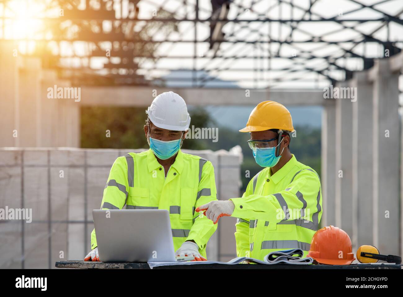 engineering and construction  in the construction site masked because effector coronavirus Stock Photo