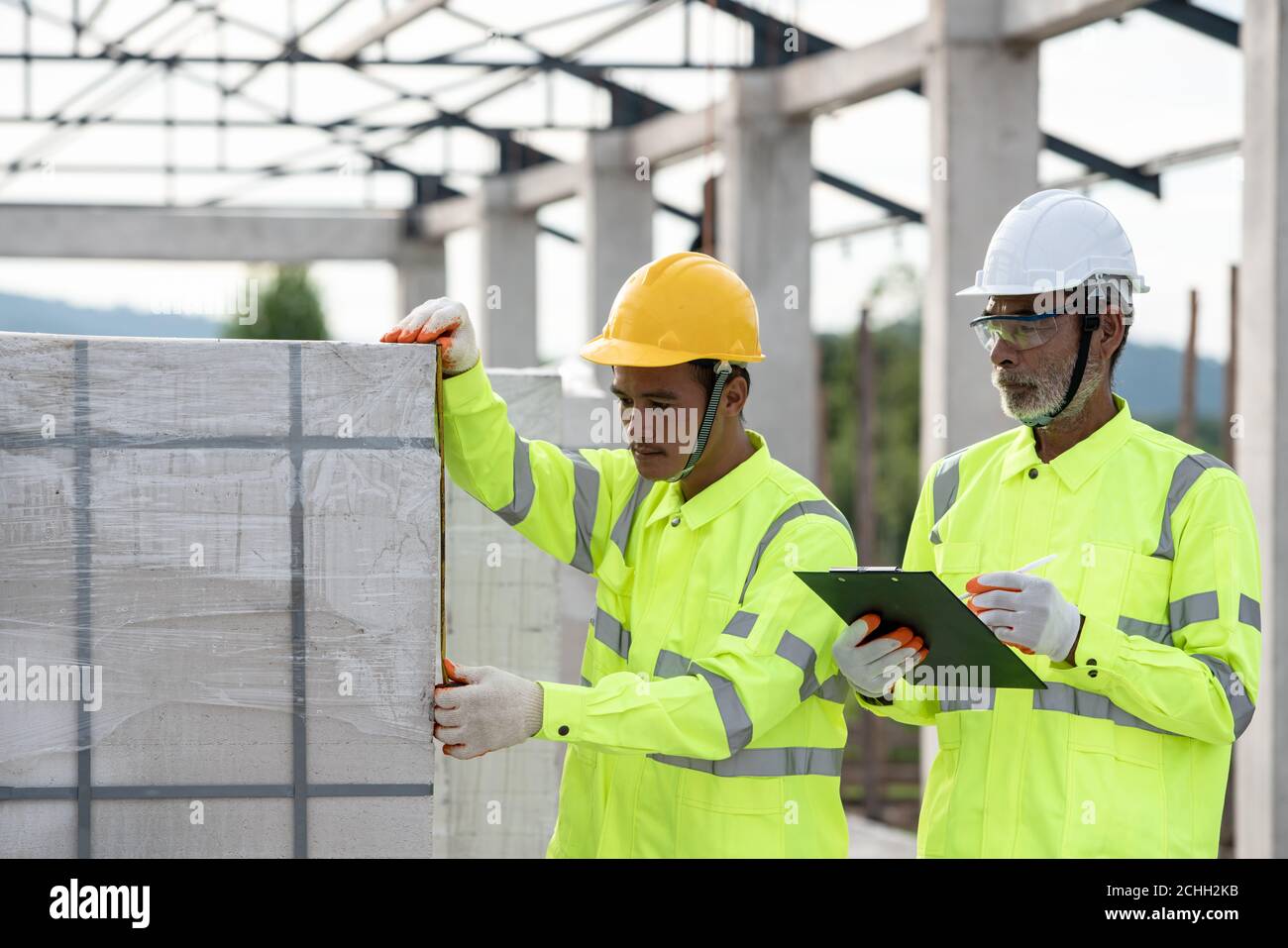 Quality inspection of aerated concrete blocks used in construction by engineers and experts Stock Photo