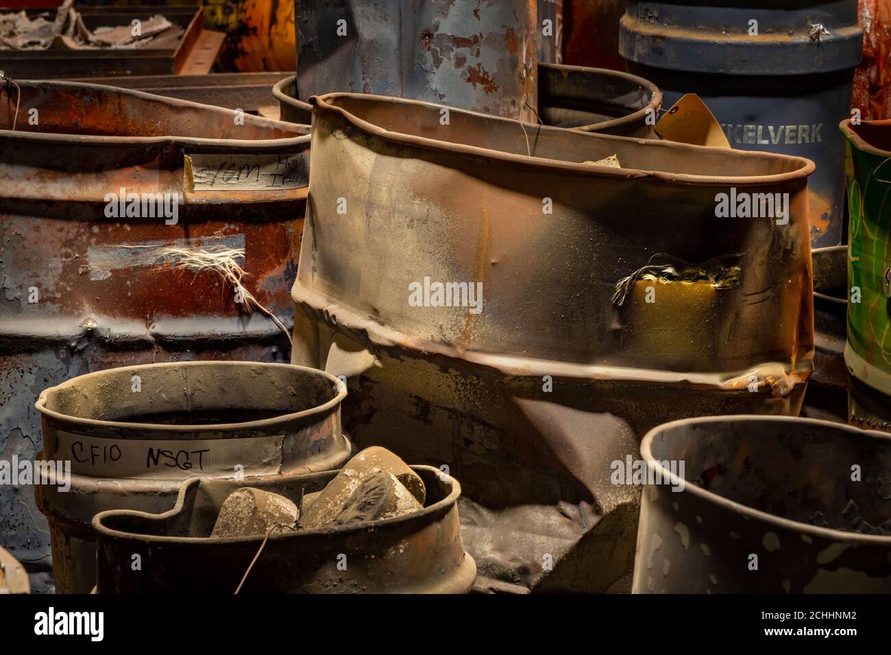 Dented and abused metal barrels in industrial refinery, Pennsylvania, USA Stock Photo