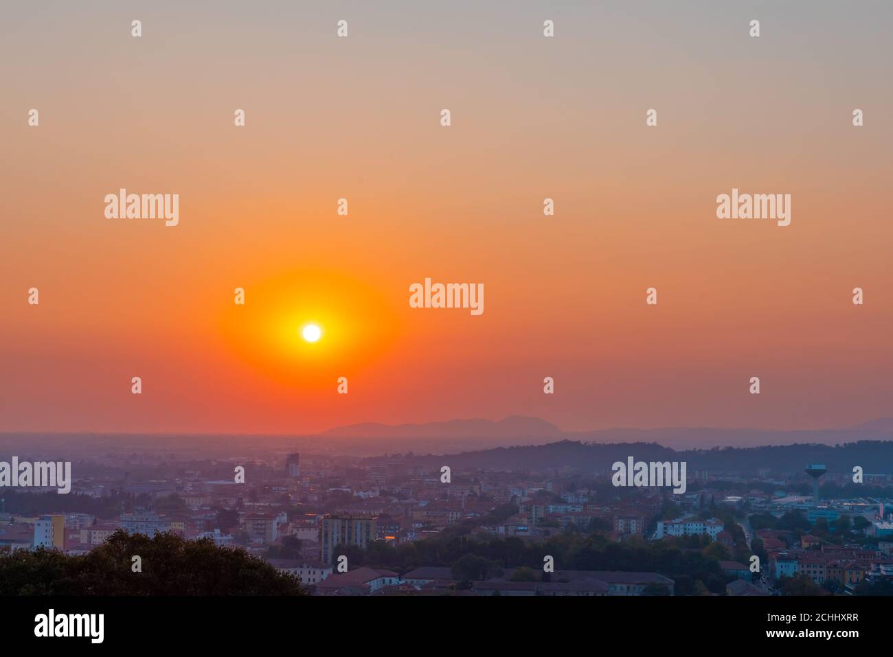 Time lapse of a sunset one hour in seven seconds. Red sunset over an urban city. Stock Photo