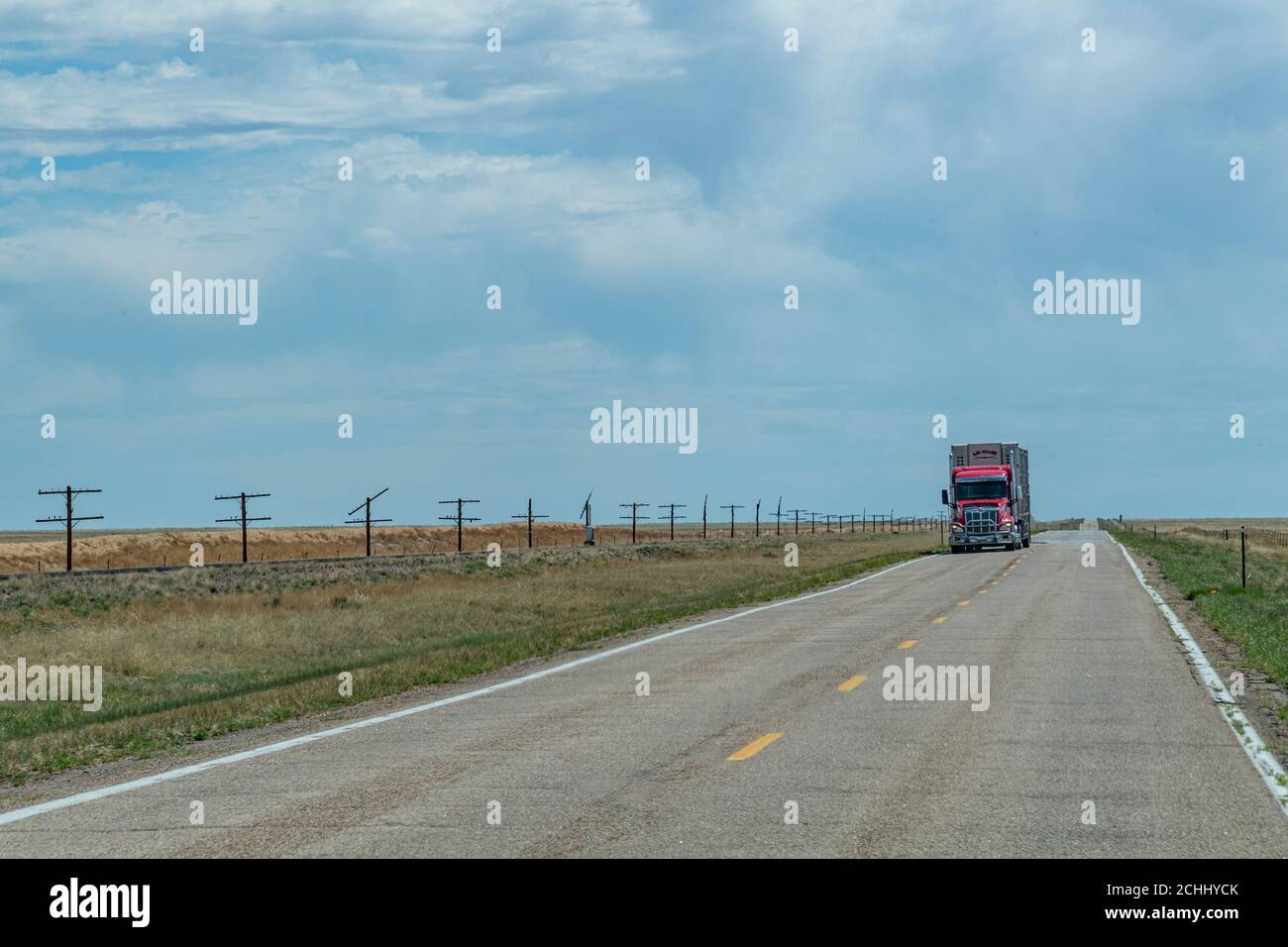 Red truck driving on open highway, Kansas, USA Stock Photo