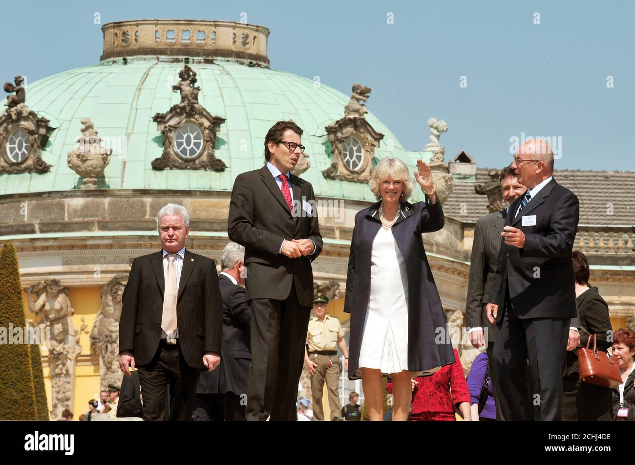 The Duchess of Cornwall waves to well-wishers during her tour of the Sans Souci Palace in Potsdam outside Berlin. Stock Photo