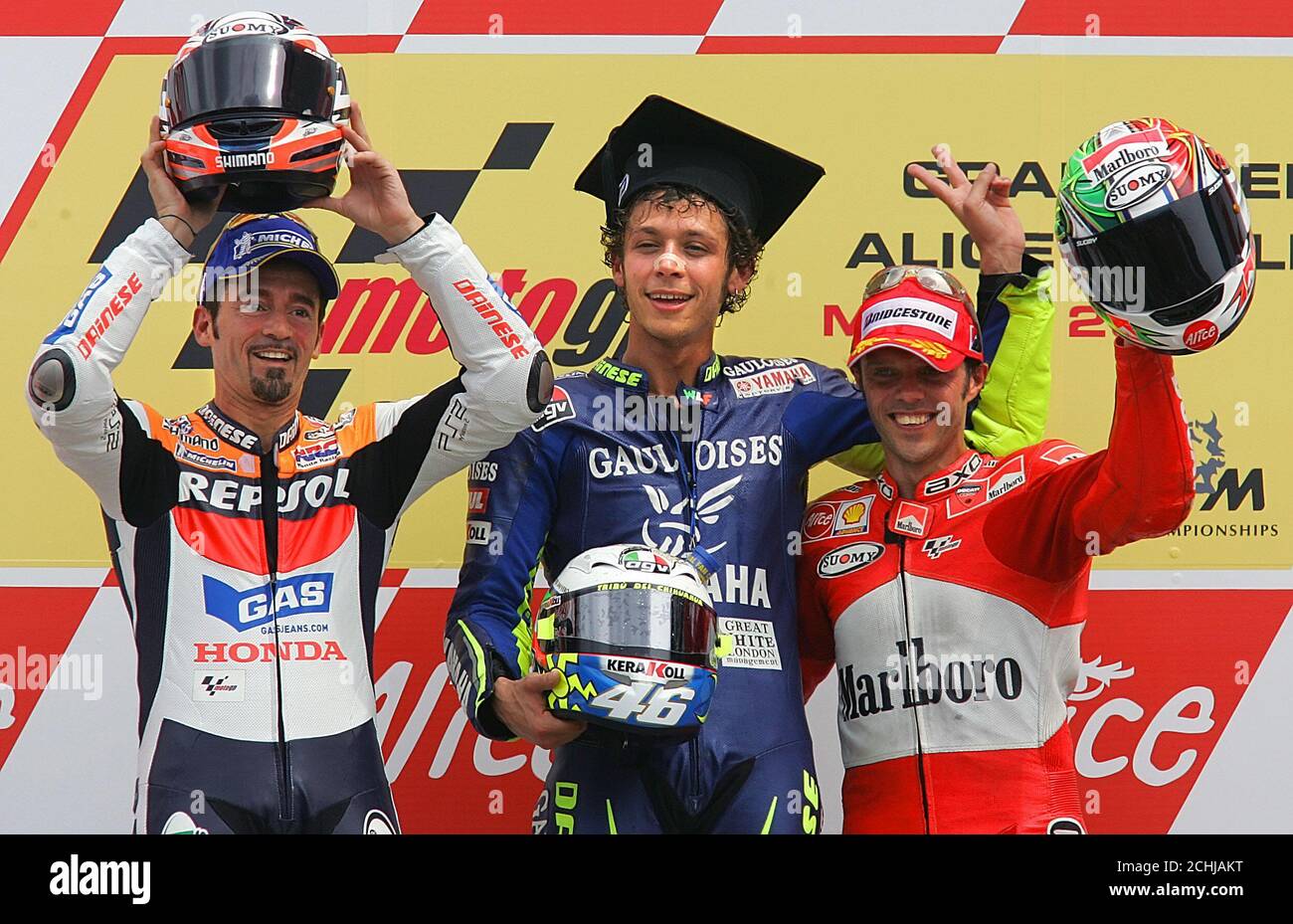 Italy's Rossi, Biaggi and Capirossi pose on the podium at the end of the  Italian Motorcycle Grand Prix in Mugello. Italy's Valentino Rossi (C) and  countrymen Max Biaggi (L) and Loris Capirossi