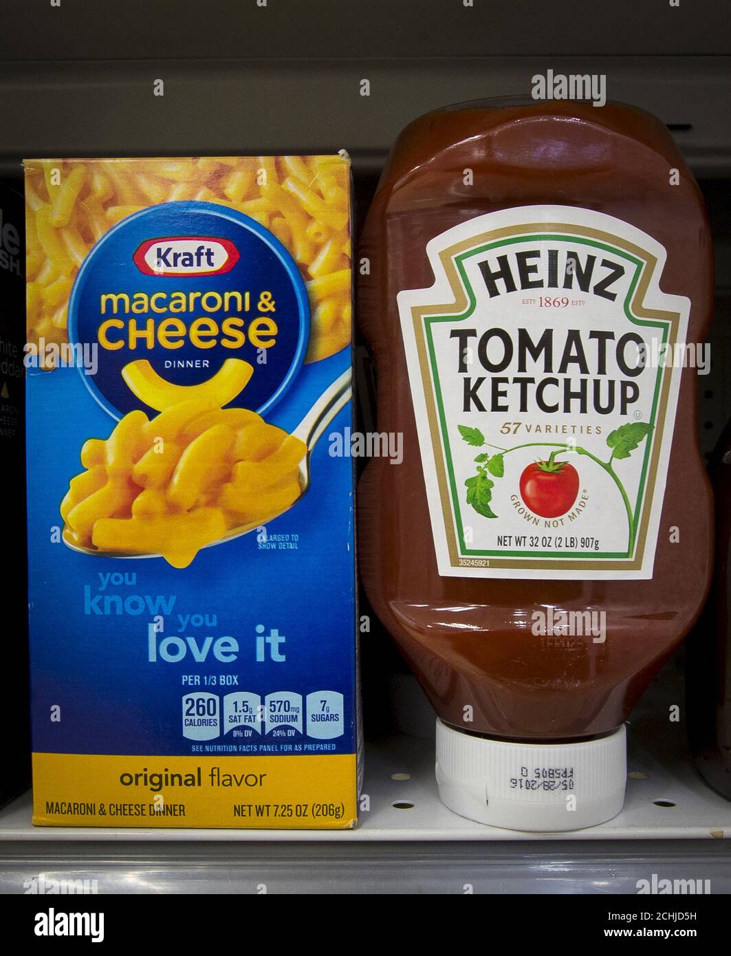 A box of Kraft macaroni and cheese and a Heinz Ketchup bottle are displayed together on a grocery store shelf in New York March 25, 2015. Kraft Foods Group Inc, the maker of Velveeta cheese and Oscar Mayer meats, will merge with ketchup maker H.J. Heinz Co, owned by 3G Capital and Berkshire Hathaway Inc, to form the world's fifth-largest food and beverage company. REUTERS/Brendan McDermid Stock Photo