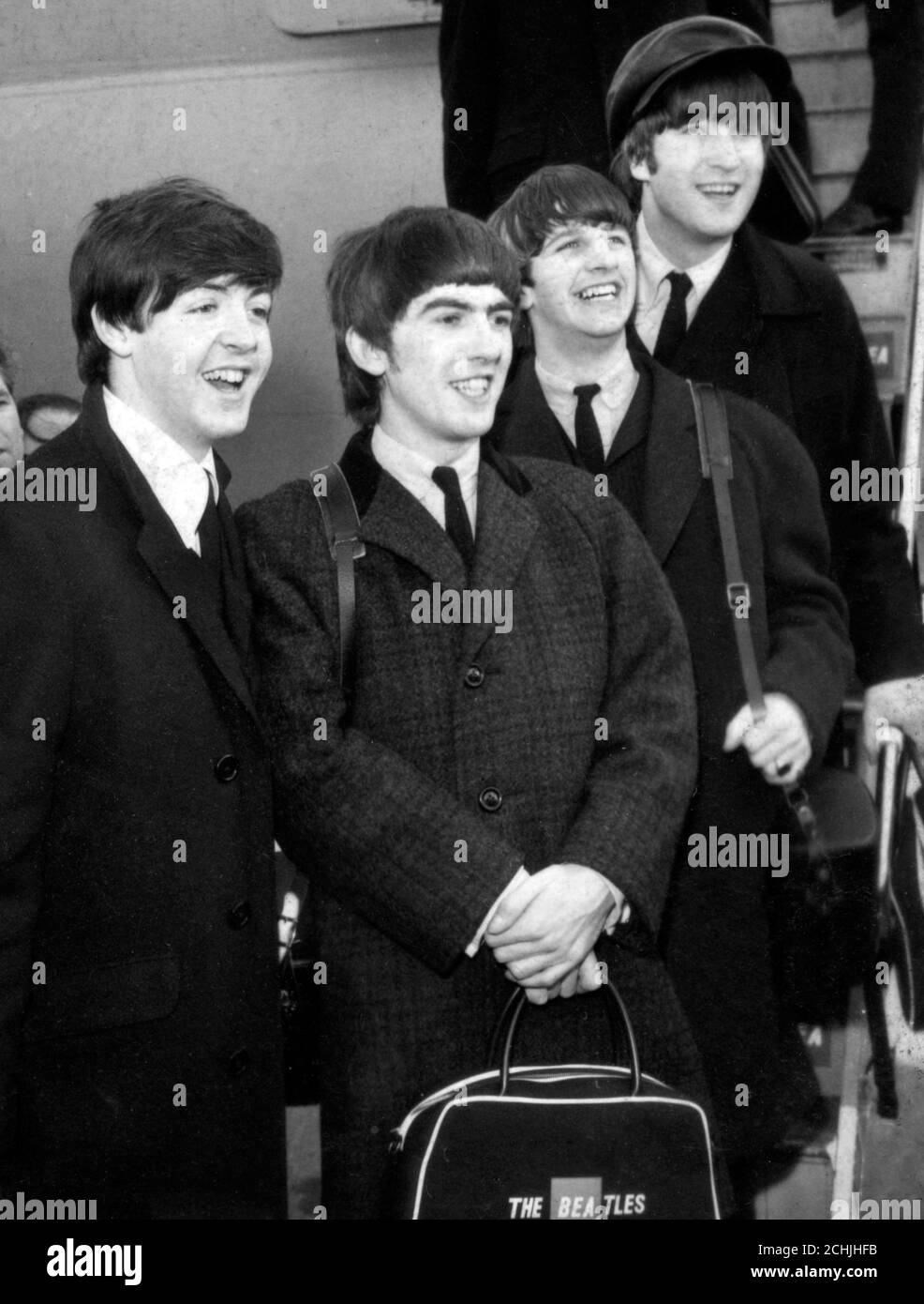 The Beatles leave the plane on arrival at London Airport from their successful appearances in Paris. (L-R) Paul McCartney, George Harrison, Ringo Starr and John Lennon. Screaming fans greeted their return. *SCANNED FROM CONTACT, NEG MISSING Stock Photo