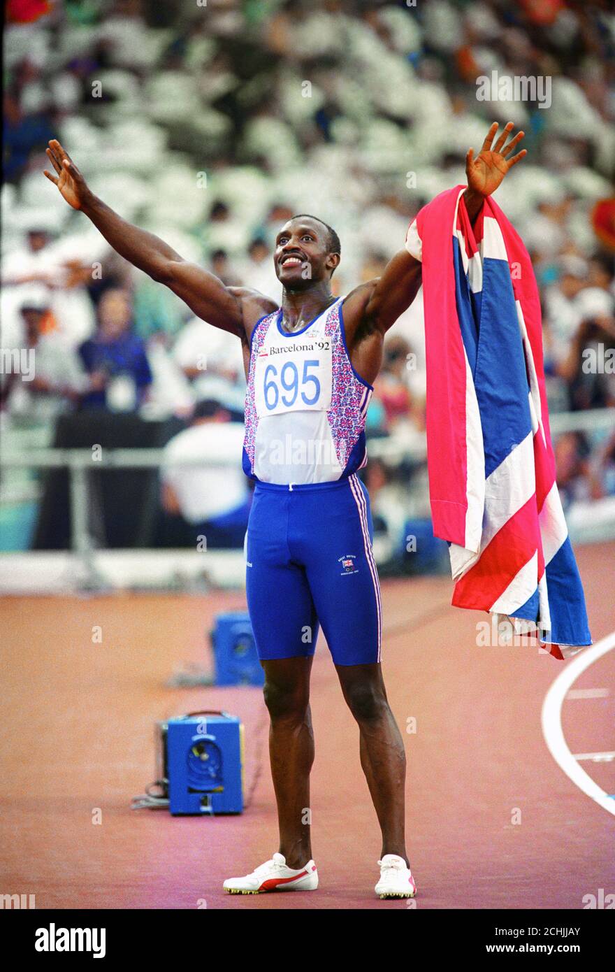 TRACK HERO, LINFORD CHRISTIE TAKES THE APPLAUSE AFTER HIS 100M OLYMPIC TITLE VICTORY IN BARCELONA.  Stock Photo
