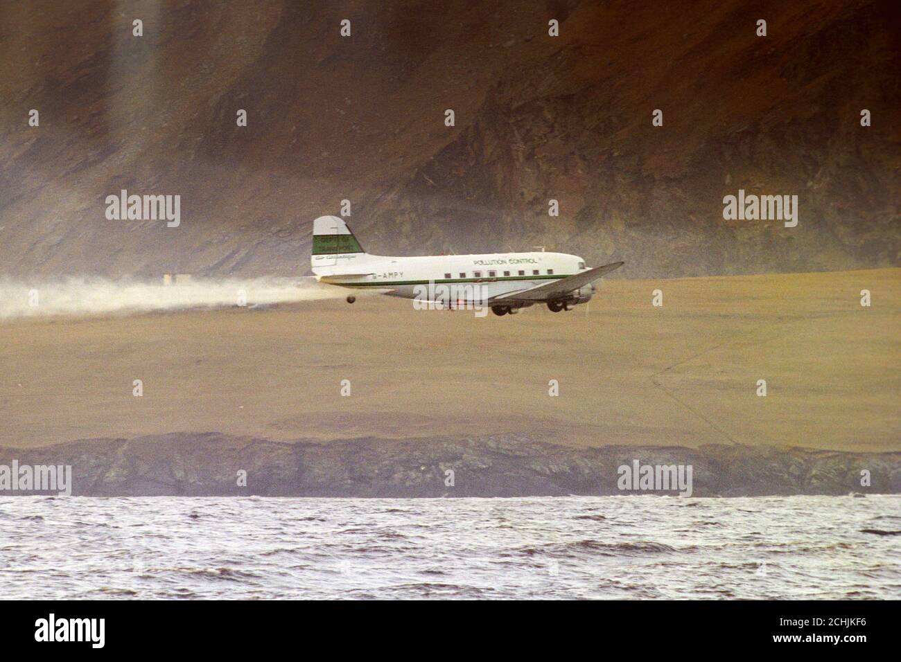 A pollution control plane sprays the sea around Sumburgh, after an oil
