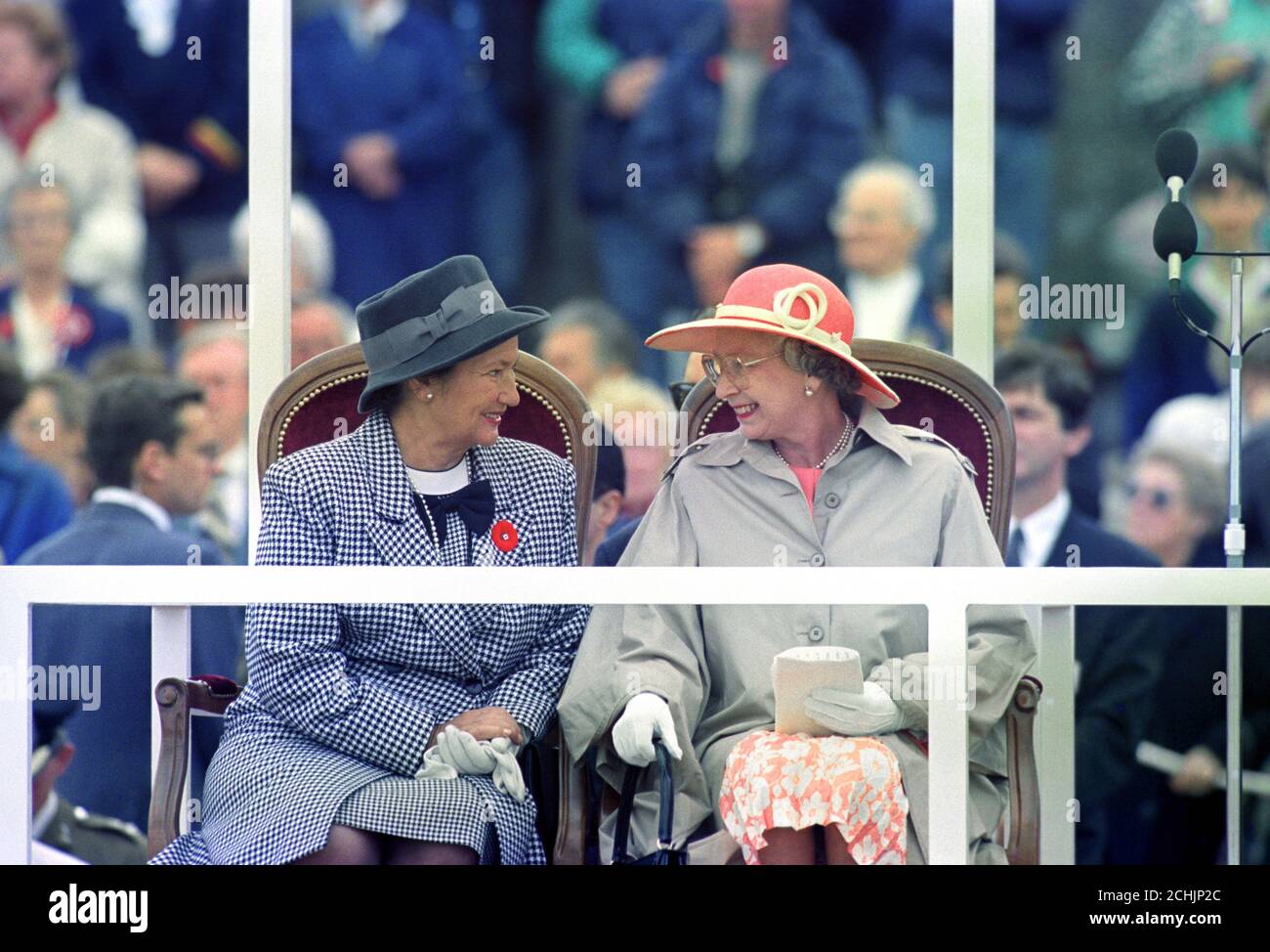 Queen Elizabeth II (r) talks to the French Government's representative, Madame Simone Veil, after making her speech at the D-Day 50th Anniversary Commemoration Service on Arromanche Beach. Stock Photo