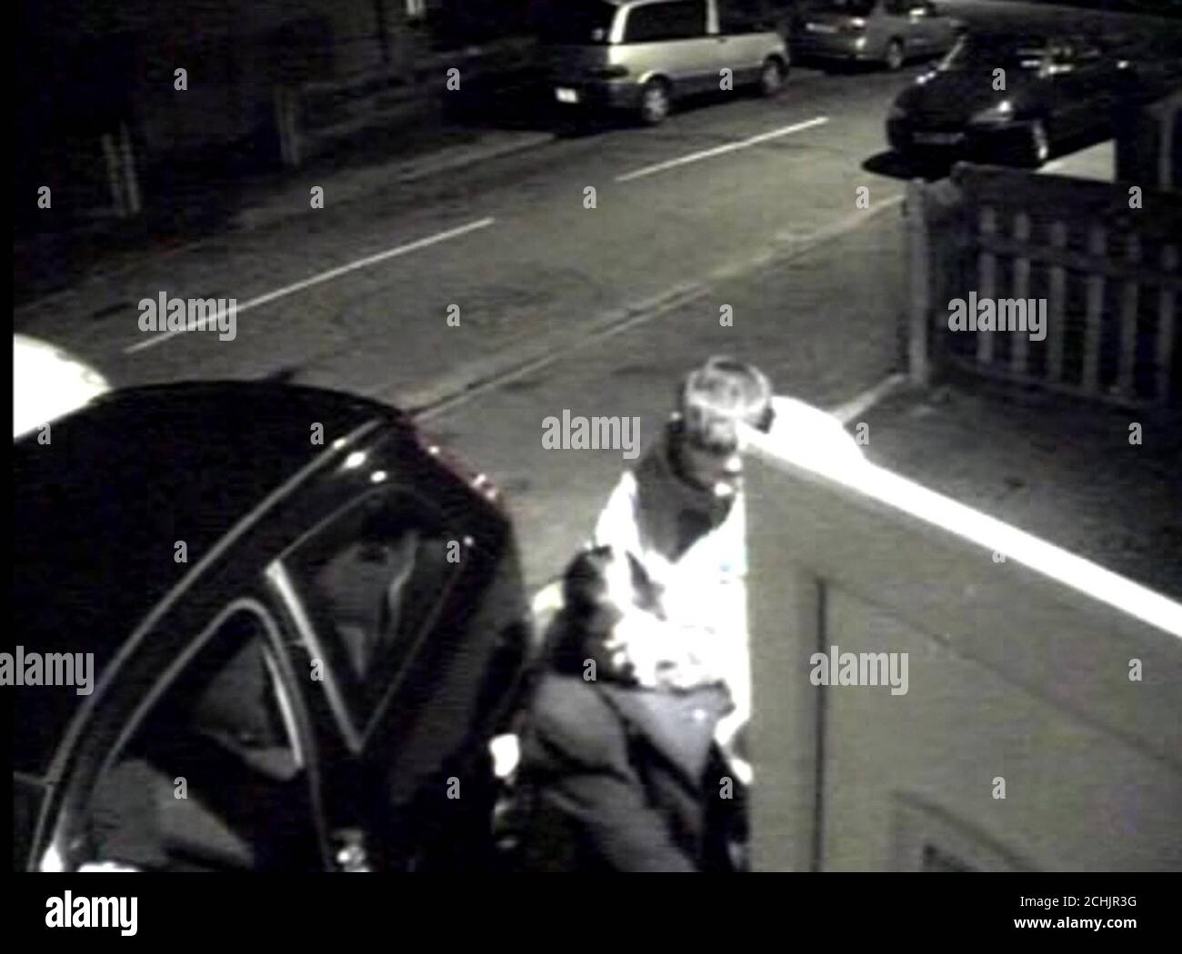 Undated video grab image from CCTV footage issued by the Metropolitan Police of the sister of Lakhvinder Cheema, Narinder Singh and her son Gurinder (right), helping Mr.Cheema (hidden by door) in to a car on their way to hospital before an ambulance arrived. This was shown to the jury at the Old Bailey, London, during the trial of Lakhvir Singh, 45, from Southall, west London who was found guilty of poisoning her former lover and his new fiancee. Stock Photo