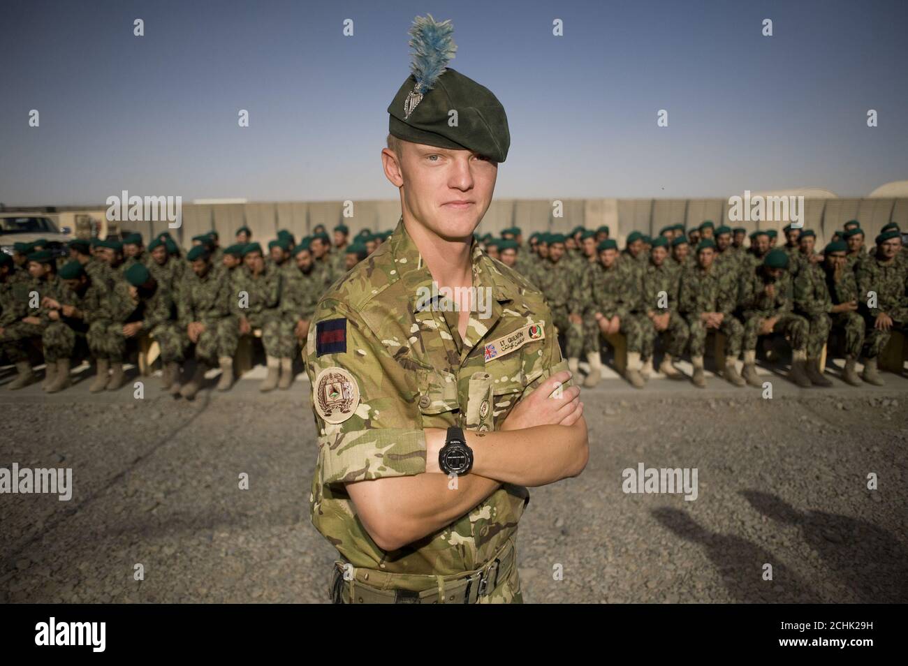 Lieutenant Pete Quentin, 27, serving with the London Regiment, a liaison officer working between the United States Marine Corps, the British Army and the Afghan National Army (ANA) during their training process stands in front of ANA soldiers prior to their graduation ceremony at Camp Leatherneck, next to the British base, Camp Bastion in Helmand Province, Afghanistan. PRESS ASSOCIATION Photo. Issue date: Thursday June 17, 2010. Camp Leatherneck is the base for 1 Marine Expeditionary Force, United States Marine Corps who lead the training of ANA soldiers. Photo credit should read: Sergeant Stock Photo