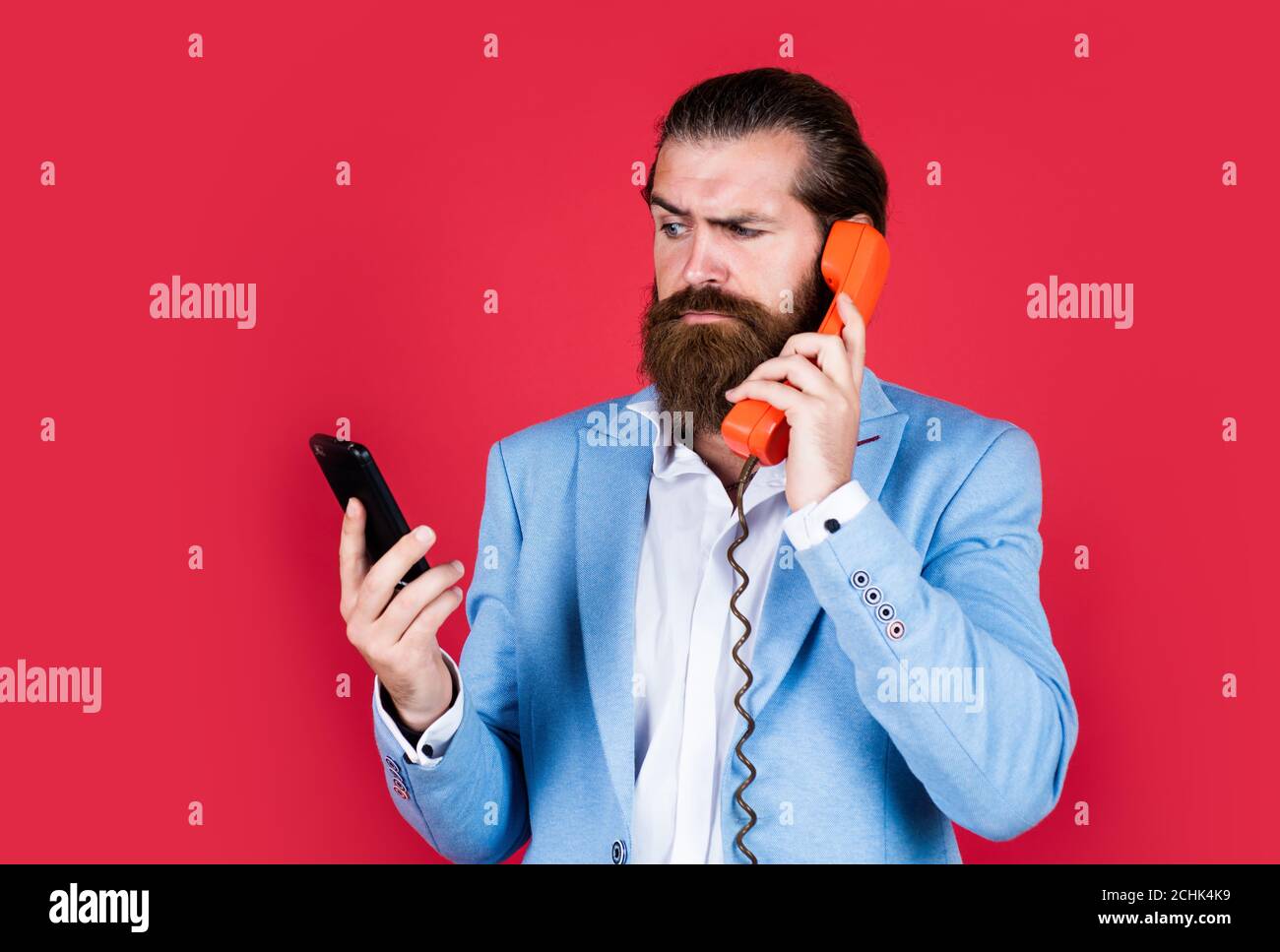 Expect the Best. Evolution of communication devices. Retro man talking on phone. Modern mobile phone and old vintage classic telephone. Technology is advancing all the time. live in Digital Age. Stock Photo