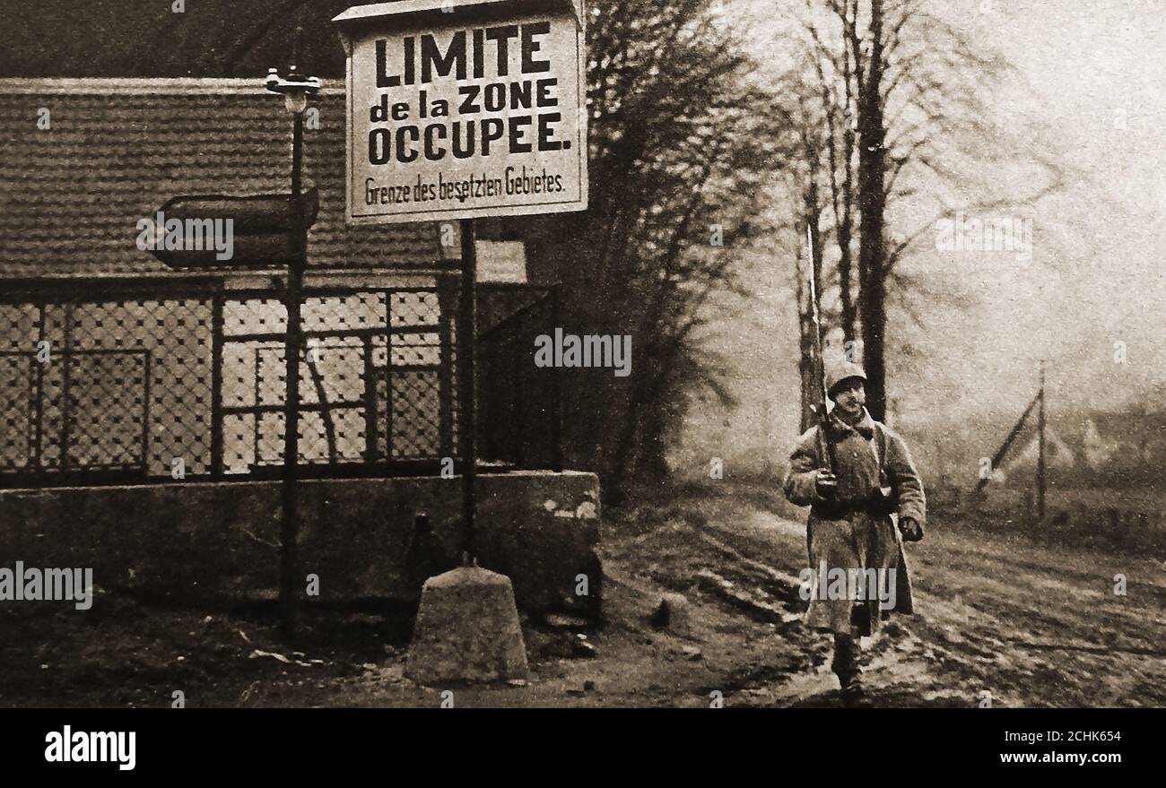 An old (1923)  photograph showing   an armed  French soldier at the limit of the French Zone of occupation in Ruhr, Germany. The Occupation of the Ruhr or Ruhrbesetzung,was a period of military occupation of that region of Germany by France and Belgium between 11 January 1923 and 25 August 1925. Occupation of the Ruhr impacted on  the economic crisis in Germany causng German civilians to  engage in acts of passive resistance and civil disobedience, during which 130 were killed. Consequently the French troops withdrew from the Ruhr  region in 1925. Stock Photo
