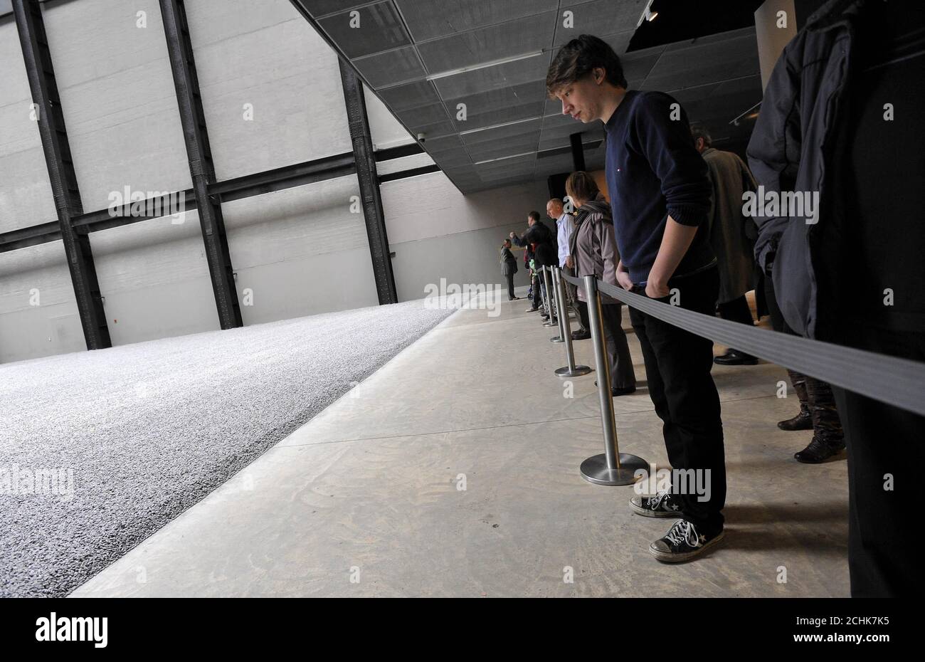 Visitors view the new Tate Modern Turbine Hall installation by Ai Weiwei in London which has been declared out of bounds after health risk concerns over dust. Stock Photo