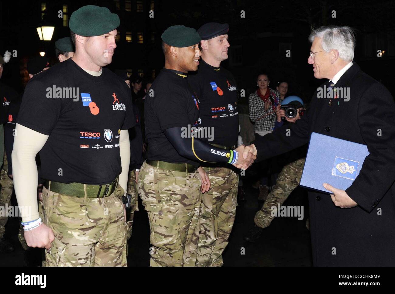 Royal Marine, Ram Pattern, shakes the hand of Lt General Sir John Kisley, the National President of the Royal British Legion after handing him the Book of Remembrance as teams from the Royal Navy, Royal Marines, Army and RAF complete the Royal British Legion's March for Honour on the steps of the Royal Albert Hall, London, following a 1,000-mile speed march which hopes to raise 1 million for the charity. Stock Photo