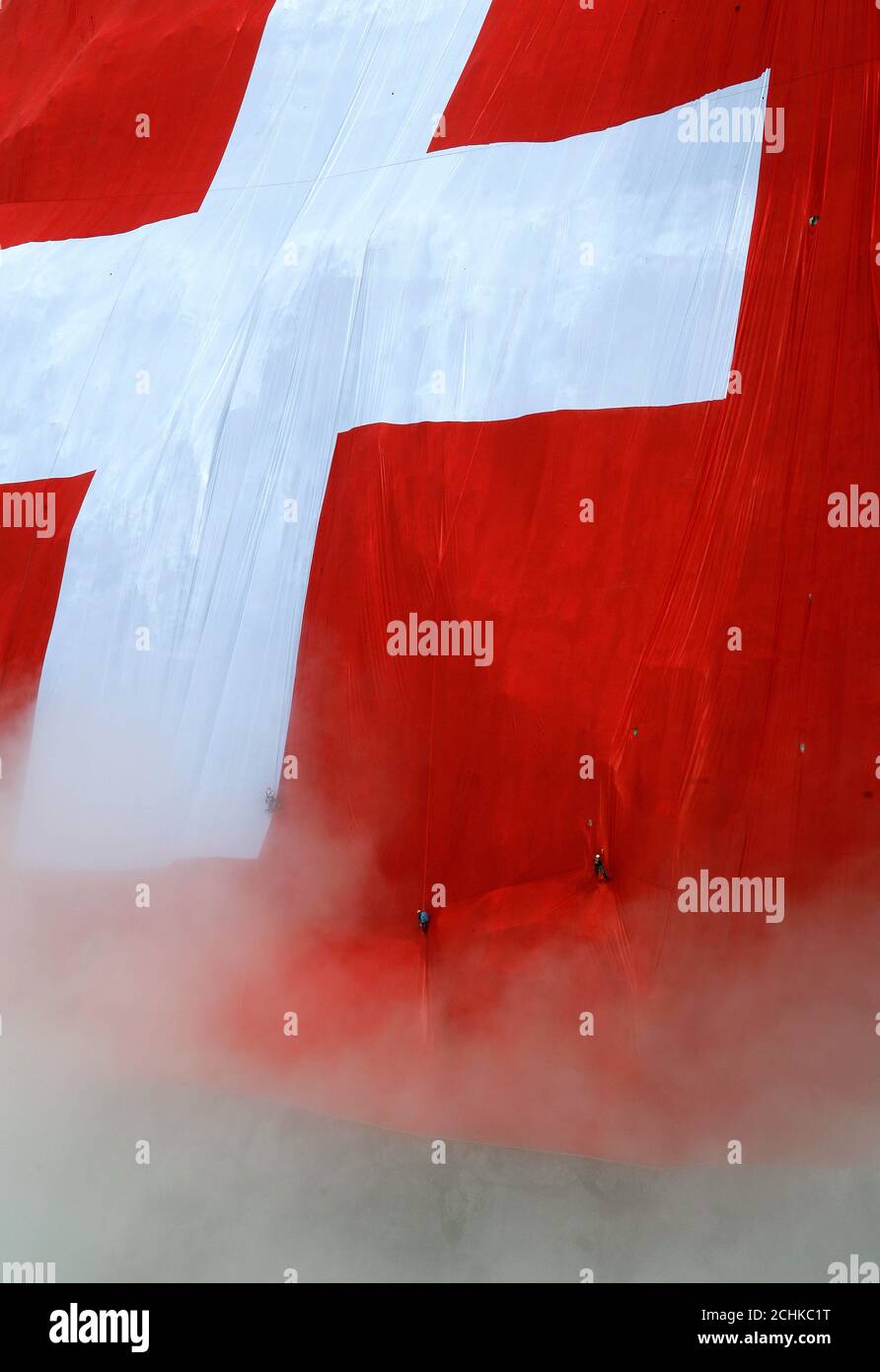 The world's largest Swiss flag is fixed by climbers on Mount Saentis (2502  meter/8209 feet above sea level) near Schwaegalp in the eastern Swiss Alps  July 30, 2009. The flag measures some