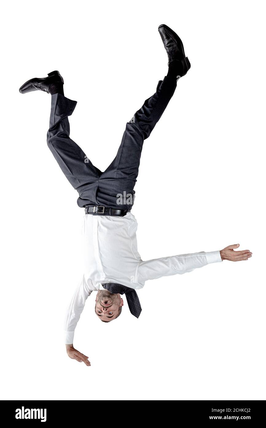 Businessman upside down balancing on one hand. isolated on white. Stock Photo