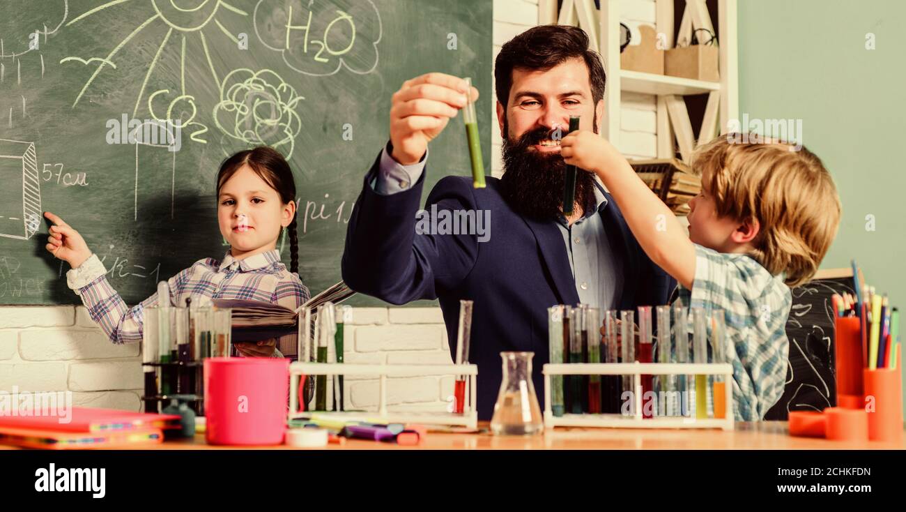 Chemistry experiment. Teacher and pupils test tubes in classroom. School clubs interactive education. Clubs for preschoolers. After school clubs are great way to develop kids in different areas. Stock Photo