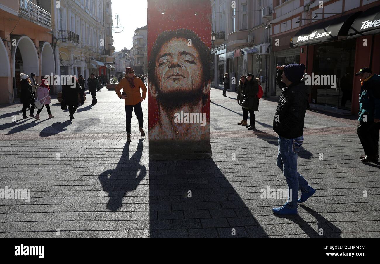 People look at a portrait of Lou Reed painted by Australian street artist Jimmy C on a section of the Berlin wall, as part of the 'Art Liberty, from the Berlin wall to the Street Art' exhibition, in Plovdiv, Bulgaria, January 12, 2019. REUTERS/Stoyan Nenov Stock Photo