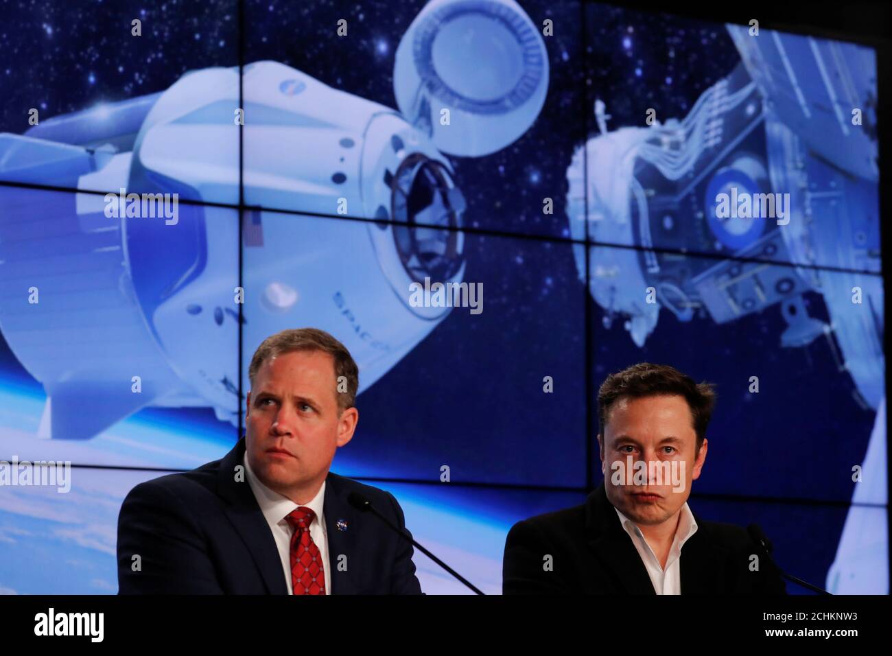 Administrator of NASA Jim Bridenstine and SpaceX founder Elon Musk listen to a question at a post-launch news conference after the SpaceX Falcon 9 rocket, carrying the Crew Dragon spacecraft, lifted off on an uncrewed test flight to the International Space Station from the Kennedy Space Center in Cape Canaveral, Florida, U.S., March 2, 2019. REUTERS/Mike Blake Stock Photo