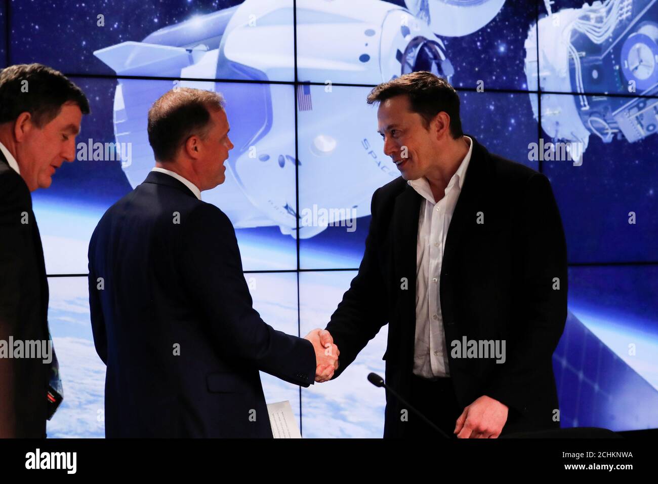 SpaceX founder Elon Musk (R) shakes hands with NASA Administrator Jim Bridenstine at a post-launch news conference after a SpaceX Falcon 9 rocket, carrying the Crew Dragon spacecraft, lifted off on an uncrewed test flight to the International Space Station from the Kennedy Space Center in Cape Canaveral, Florida, U.S., March 2, 2019. REUTERS/Mike Blake Stock Photo