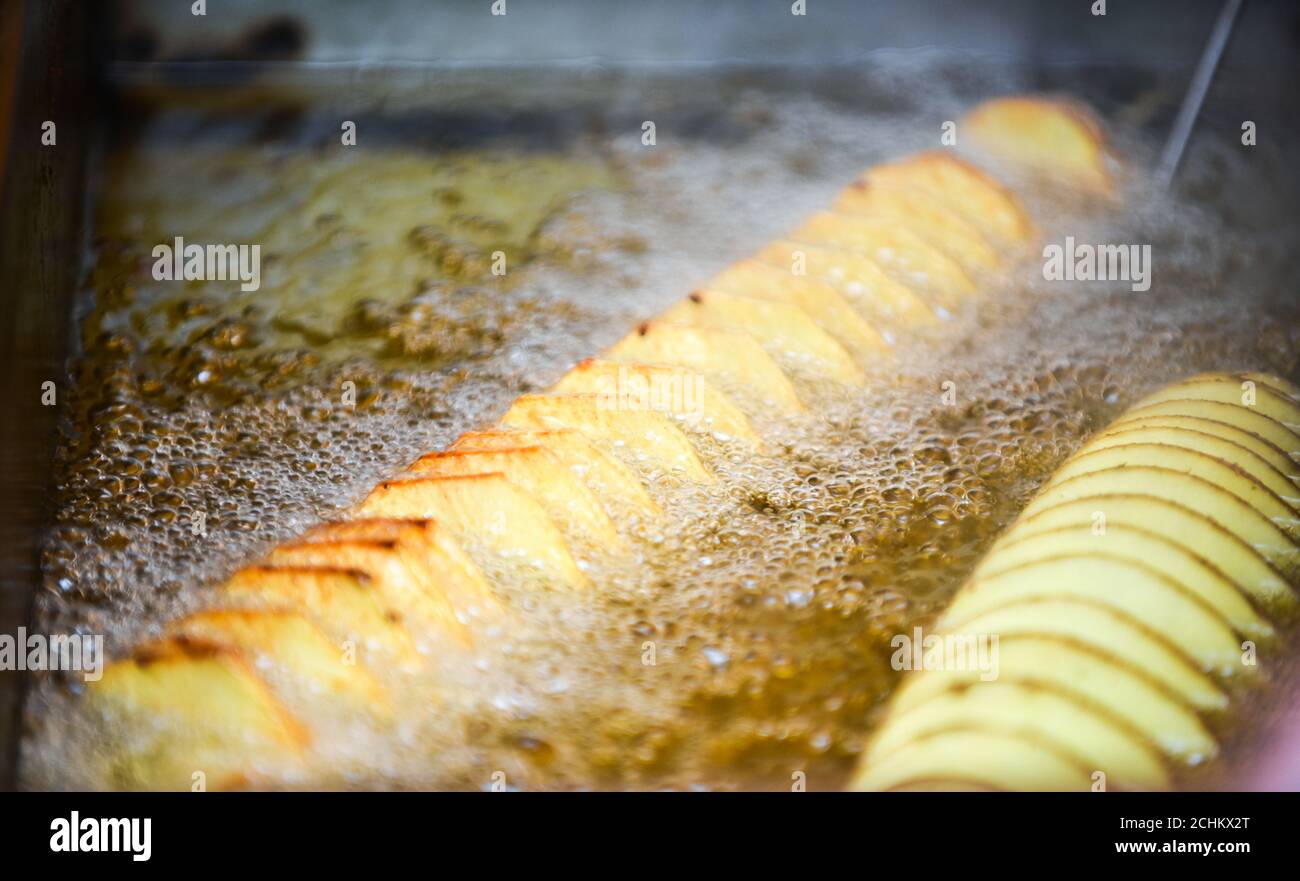 French fries frying in hot oil Stock Photo Alamy