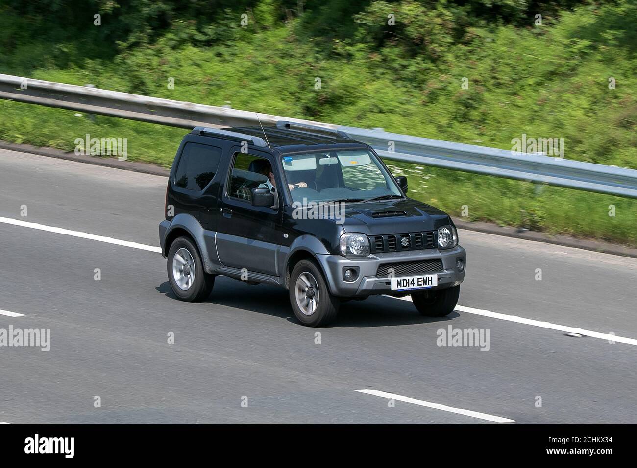 2014 black Suzuki Jimny SZ4 driving on the M6 motorway near Preston in Lancashire, UK. Stock Photo