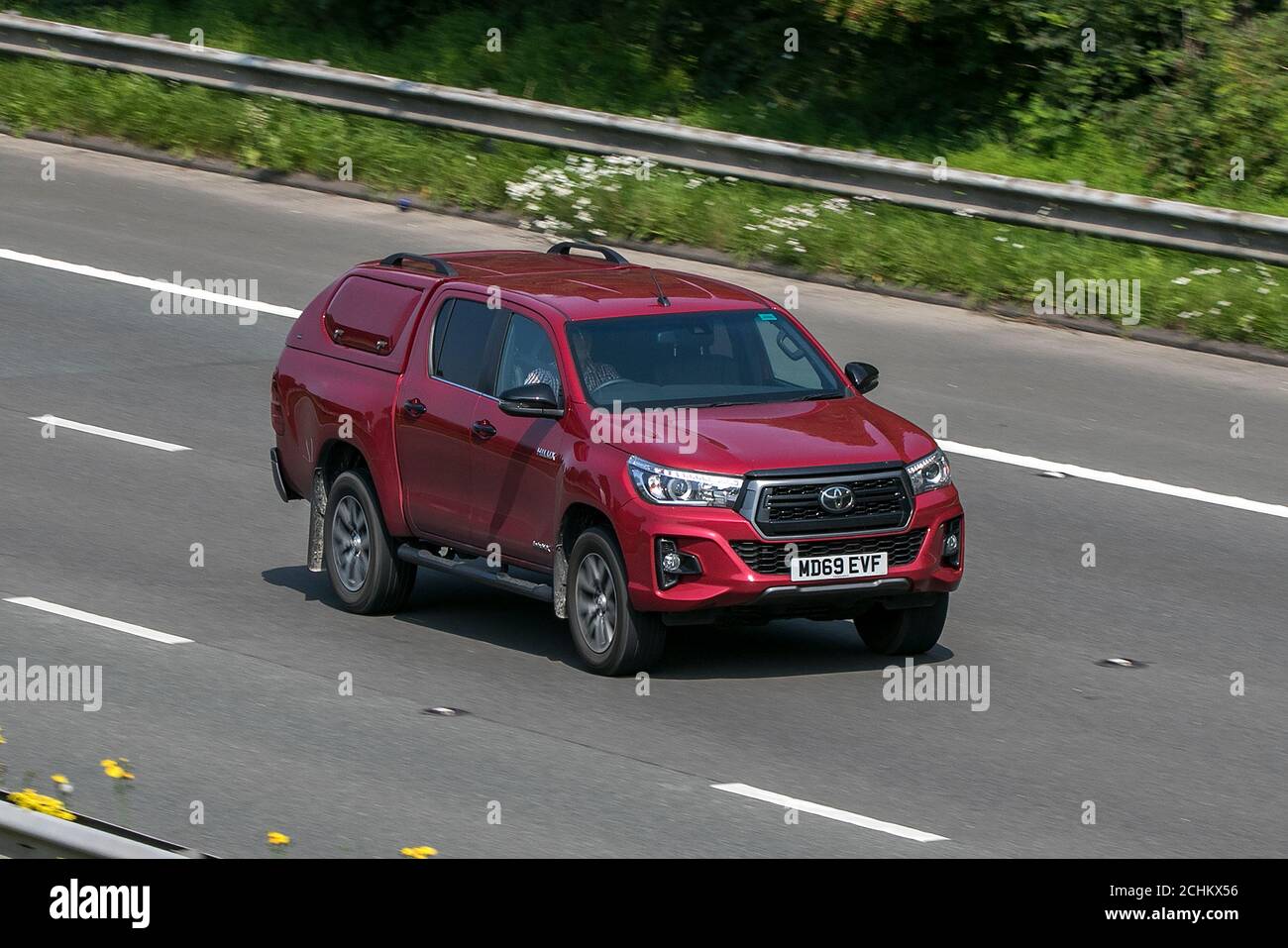 2020 Toyota Hilux Invincible X D-4D4wd Red LCV Double Cab Pick Up Diesel driving on the M6 motorway near Preston in Lancashire, UK. Stock Photo