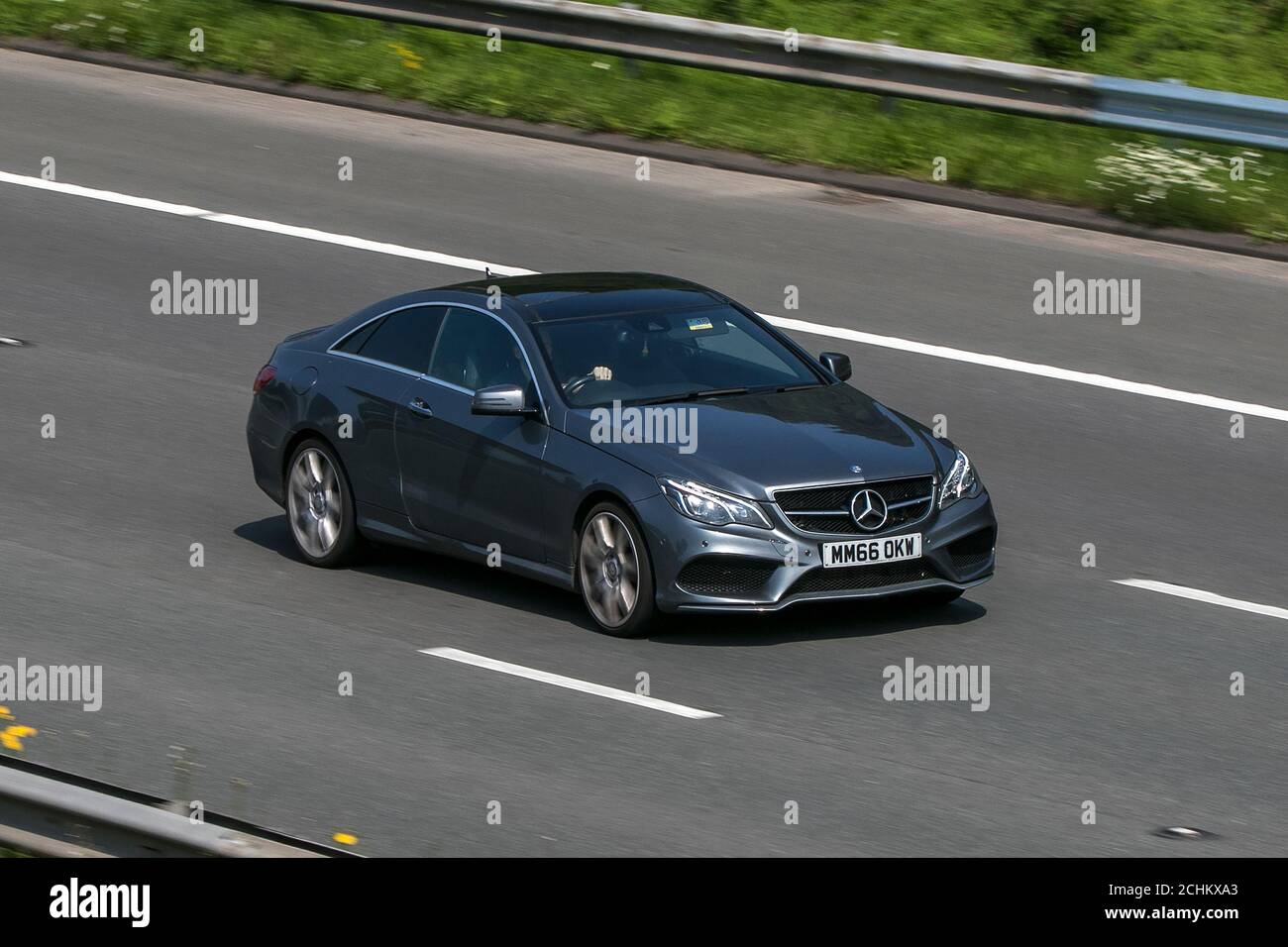 2016 Mercedes-Benz E 220 Amg Line Edition Grey Car Coupe Diesel driving on the M6 motorway near Preston in Lancashire, UK. Stock Photo