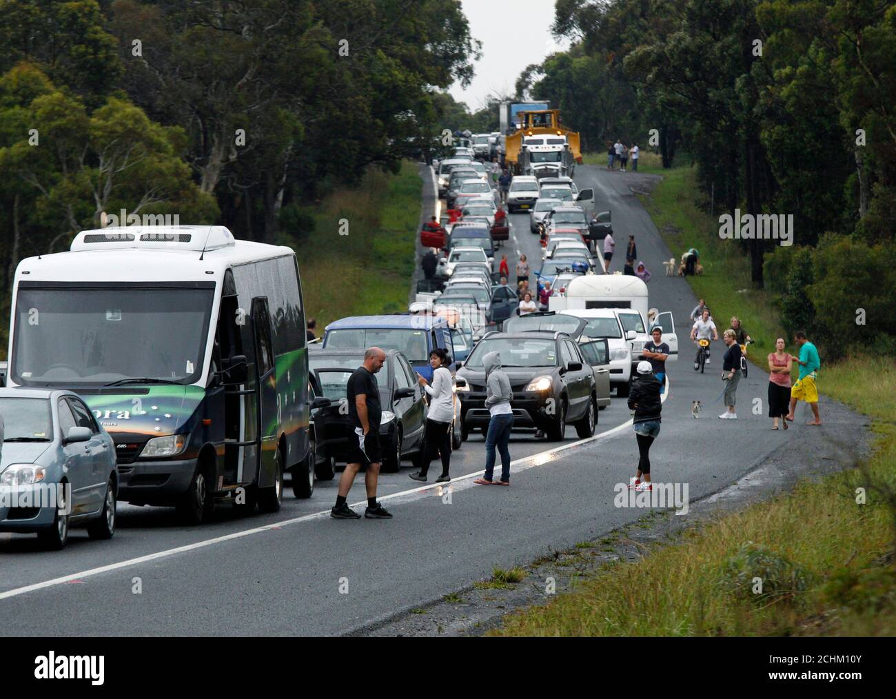 Motorists walk around their stationary cars while caught in a major traffic jam caused by a truck accident on the Hume Highway near Goulburn, March 7, 2010. The state road and traffic authority reported that the accident caused a 25 km (15 miles) long traffic jam.       REUTERS/Tim Wimborne   (AUSTRALIA - Tags: DISASTER TRANSPORT SOCIETY) Stock Photo