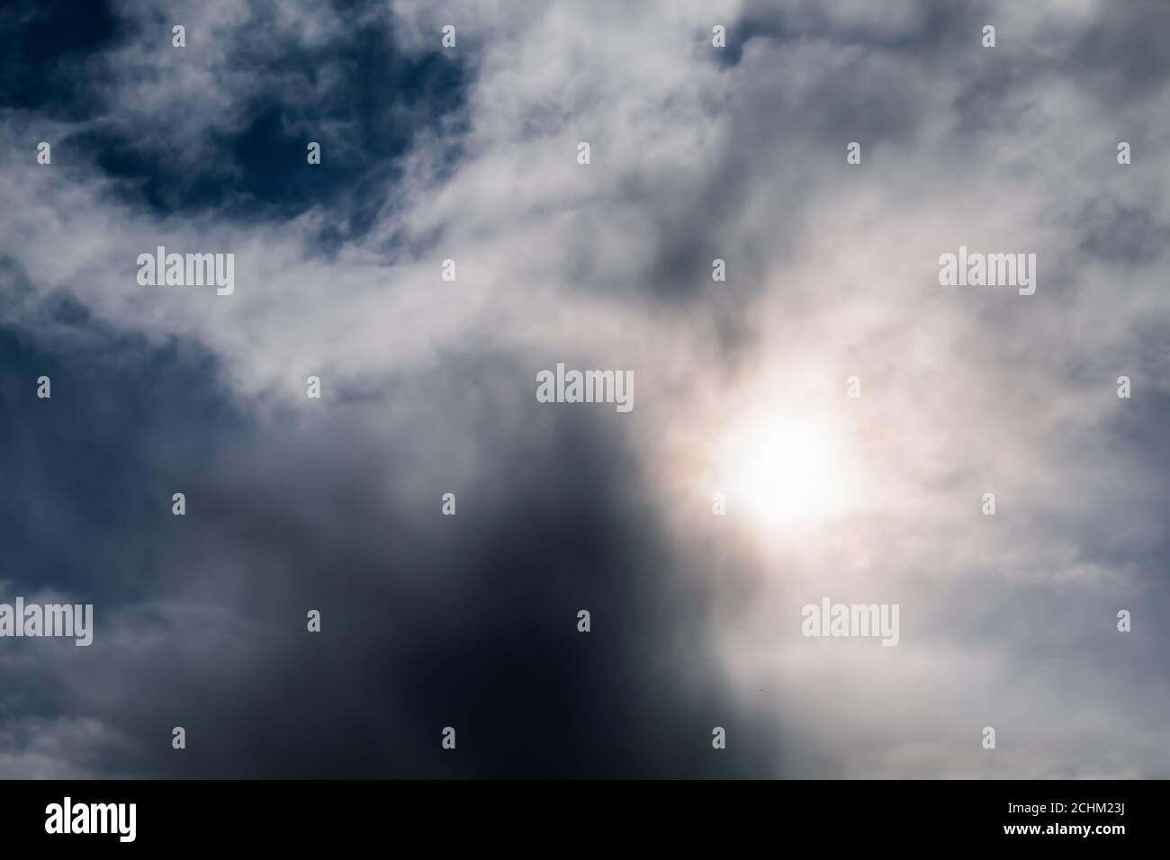 Beautiful scenery of the sun hiding behind dark storm clouds Stock ...