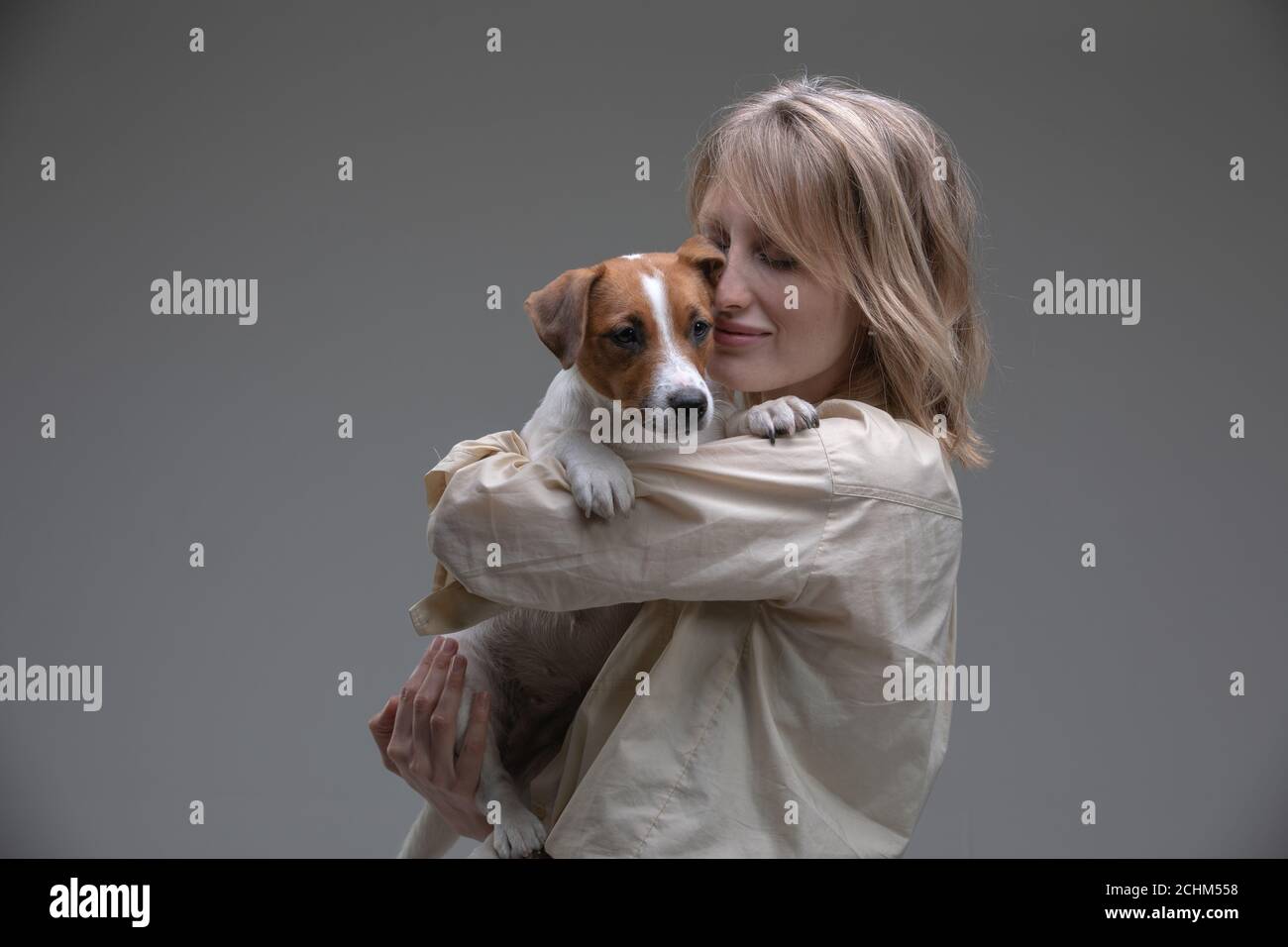 Muffin the Dog in Vintage Shoulder Pads, sitting on Locker Room Bench Next  to Football Helmet Stock Photo