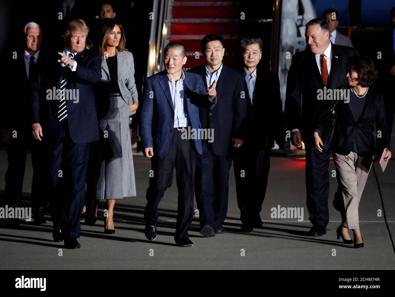 The three Americans formerly held hostage in North Korea, Tony Kim, Kim Hak-song and Kim Dong-chul, walk next to U.S.President Donald Trump, first lady Melania Trump, U.S. Vice President Mike Pence and U.S. Secretary of State Mike Pompeo at Joint Base Andrews, Maryland, U.S., May 10, 2018. REUTERS/Jim Bourg Stock Photo