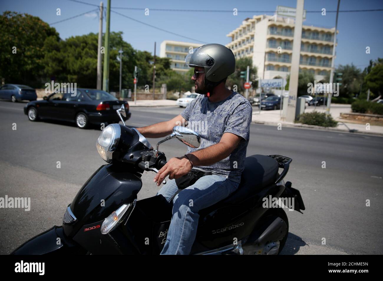 Delivery worker Nikos Vourliotis, 42, rides his bike in Glyfada suburb,  near Athens, Greece June 27, 2019. Picture taken June 27, 2019.  REUTERS/Costas Baltas Stock Photo - Alamy