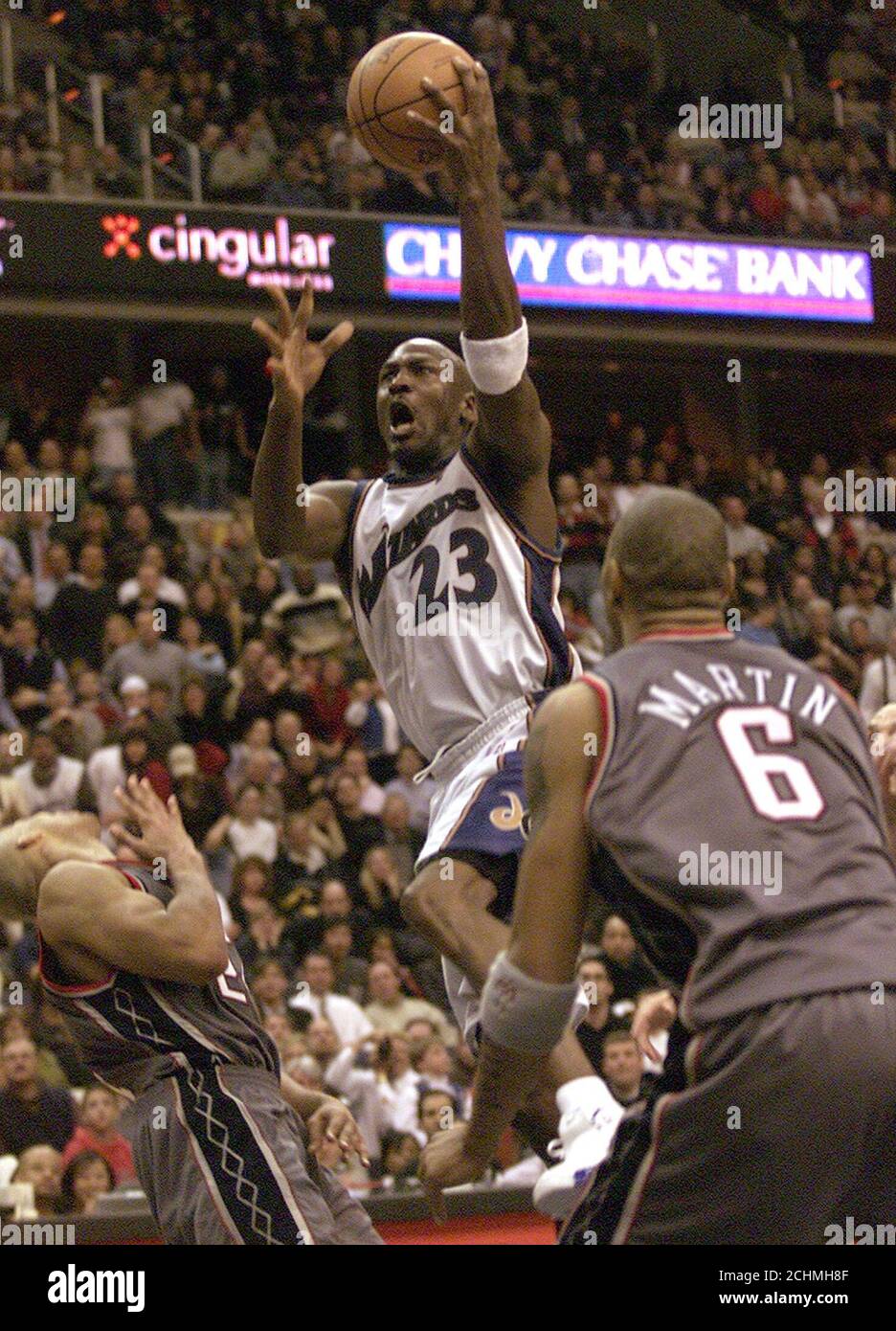 Washington Wizards' guard Michael Jordan (23) goes up for the game winning point against the New Jersey Nets, in the final seconds of the fourth quarter February 21, 2003 at the MCI Center in Washington. Watching Jordan are New Jersey forwards Richard Jefferson (L) and Kenyon Martin (6). Jordan, who turned 40-years-old this week, had 43 points for the evening as the Wizards defeated the Nets, 89-86. REUTERS/Brendan McDermid  BM/HB Stock Photo