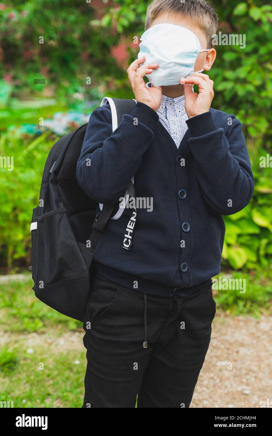 school child boy wearing medical face mask. preteen with school bag ...