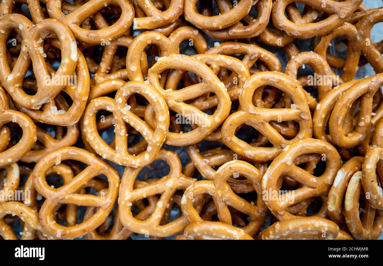 Mini salted pretzels. Full frame close detail abstract background texture of a bowl of mini salted pretzels. Stock Photo