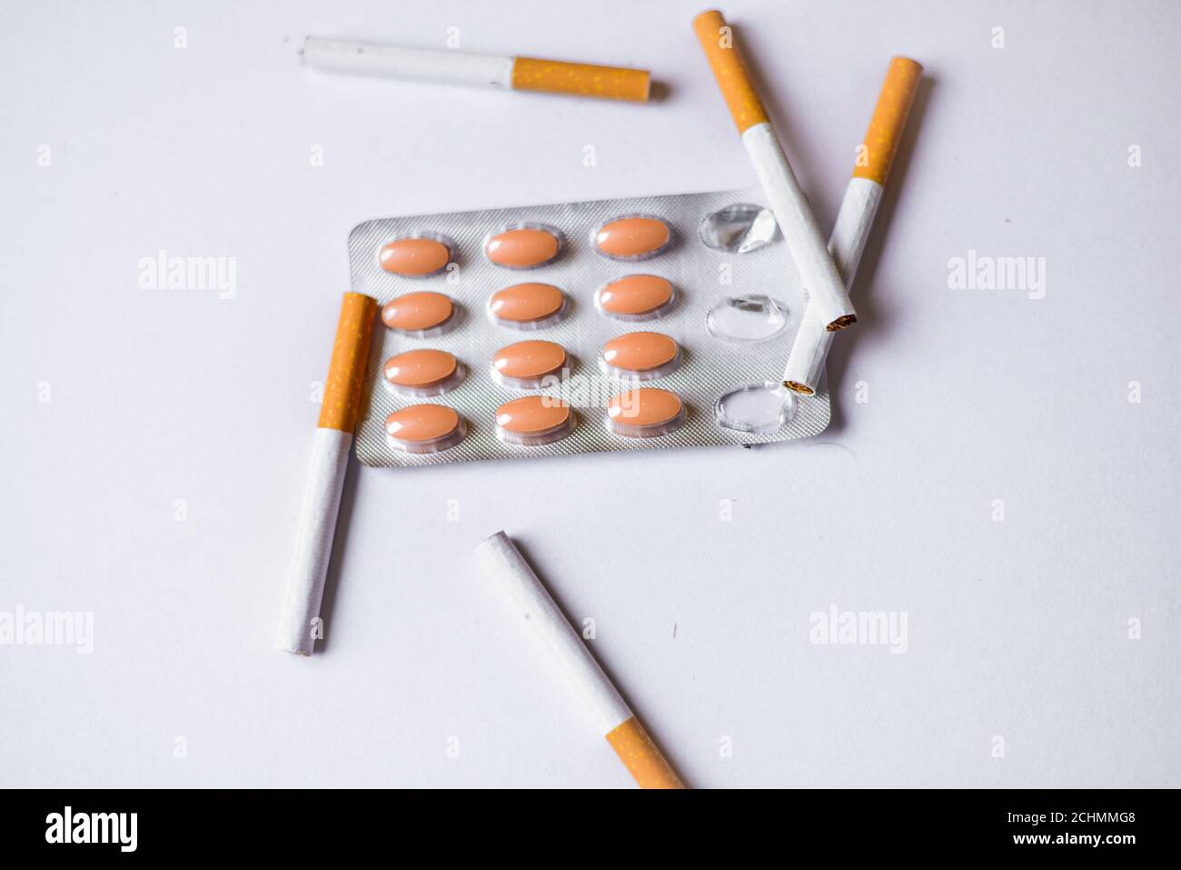 Cigarettes and Medicine on a table. Smoking causes cancer and emphysema.  Health Care concept Stock Photo