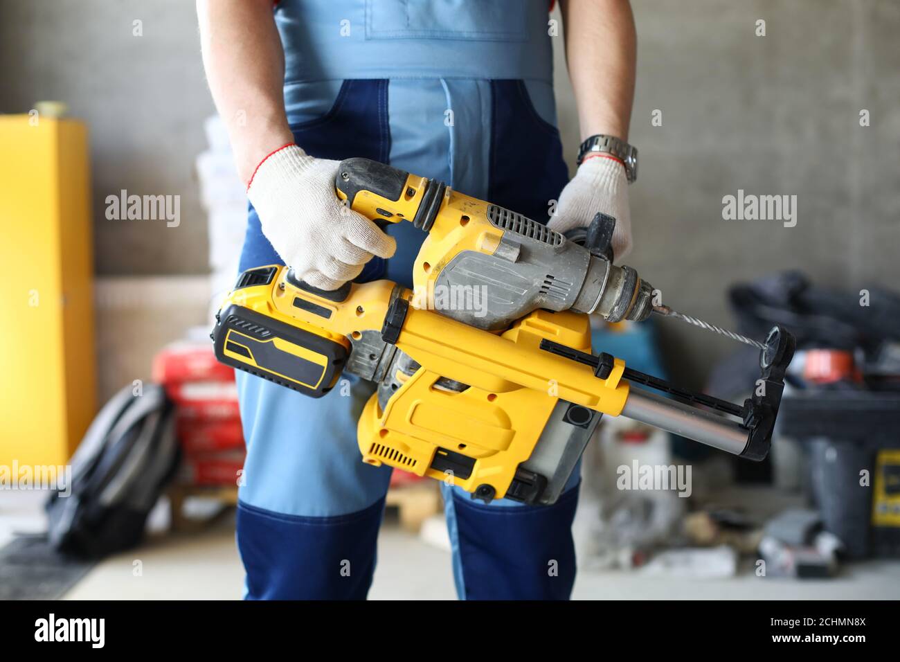 Builder holding perforator instrument in hand Stock Photo