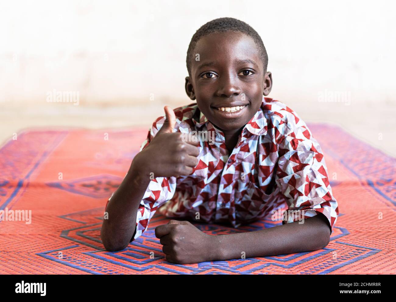 Cheerful African Black Boy Thumbs Up Symbol with Hands Stock Photo