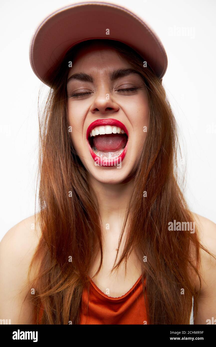 Woman in a cap Closed eyes open mouth tongue evening makeup Stock Photo -  Alamy