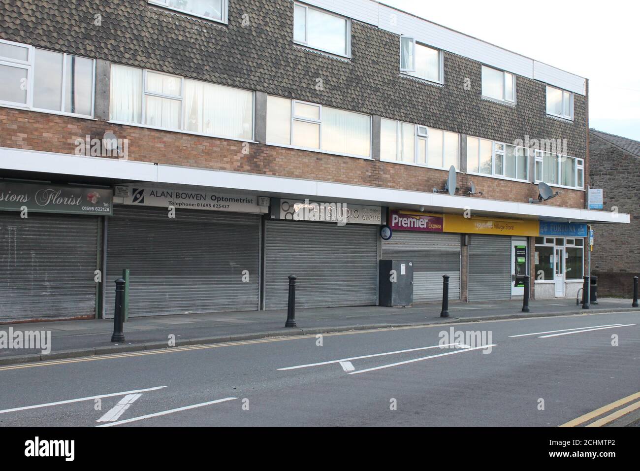 Row of village shops with shutters down, closed shops, UK closed shops Stock Photo
