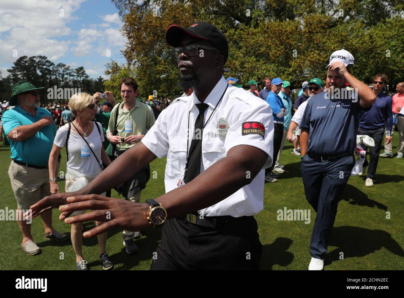 Shane Lowry of Ireland is guided through the crowd by security during the  second day of practice for the 2019 Masters golf tournament at the Augusta  National Golf Club in Augusta, Georgia,