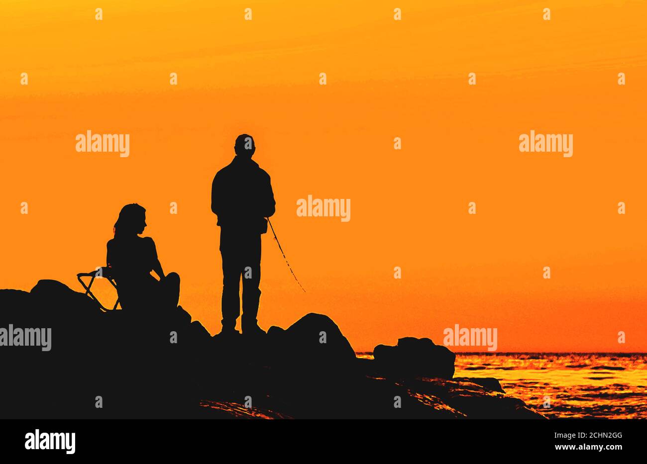 Fisherman on rocky shore sunset hi-res stock photography and images - Alamy