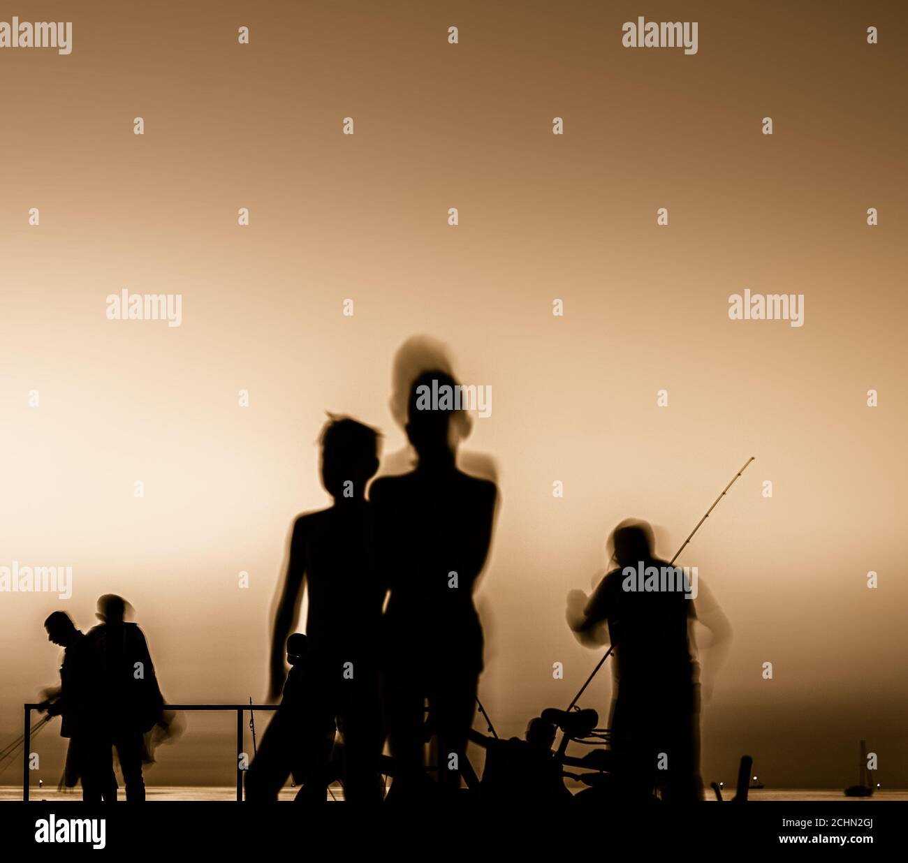silhouette of fishermen at sunset Stock Photo - Alamy