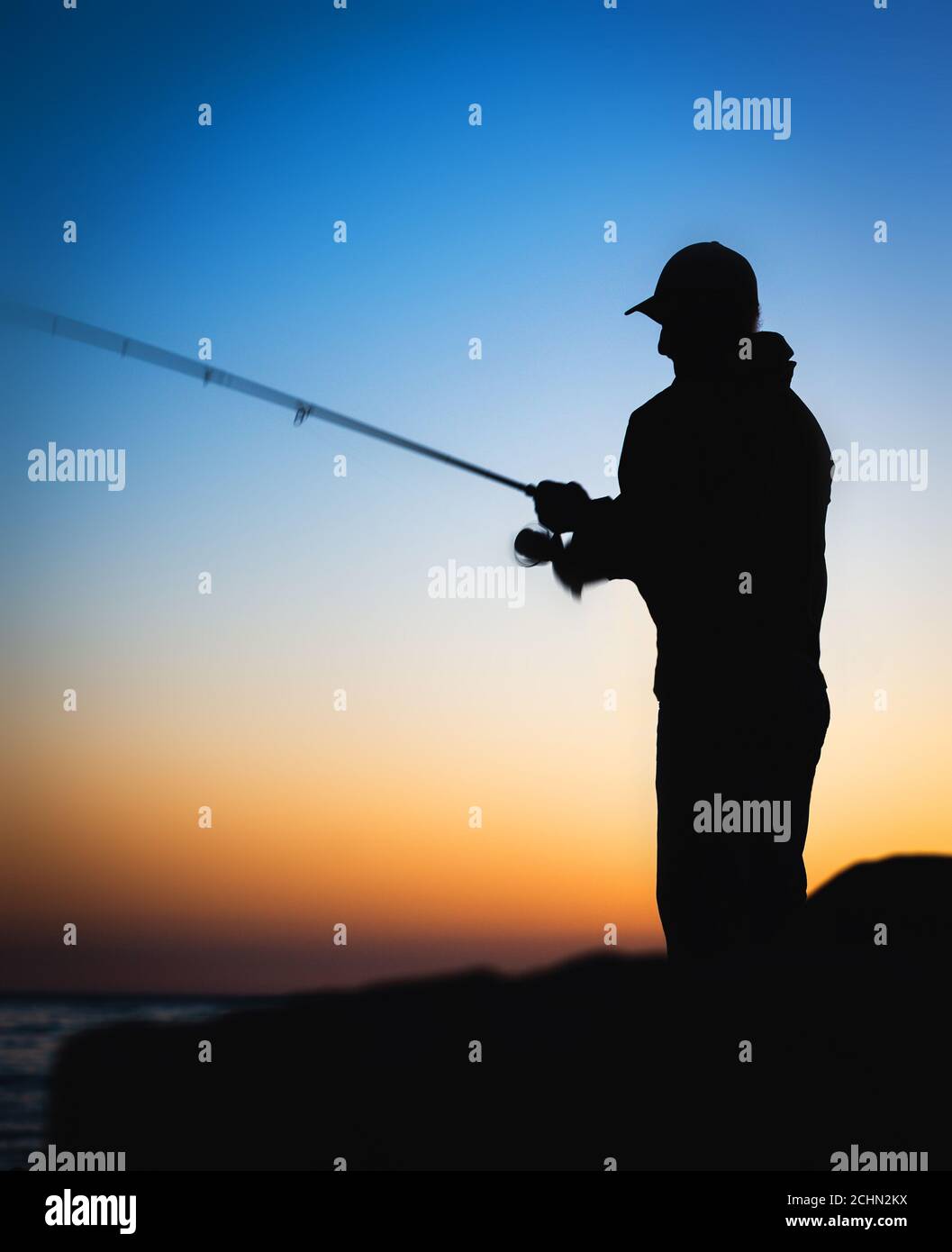 Silhouette of man fishing hi-res stock photography and images - Alamy