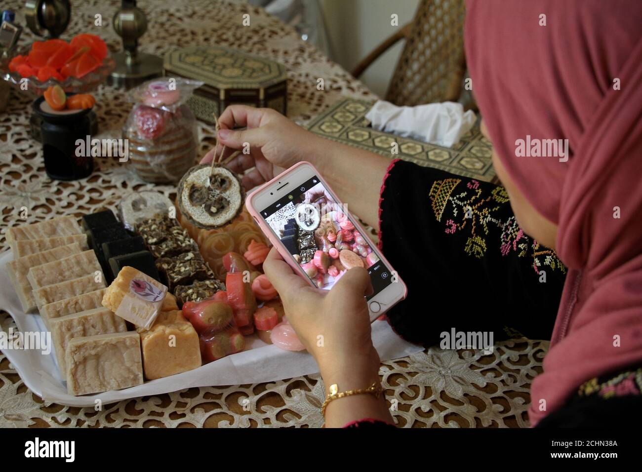 Gaza. 12th Sep, 2020. Asmaa Yassin takes photos of the soaps she makes to sell online at her house in Gaza City, on Sept. 12, 2020. Gazans have resorted to online shopping to buy necessities during the lockdown amid the COVID-19 outbreak. Credit: Rizek Abdeljawad/Xinhua/Alamy Live News Stock Photo
