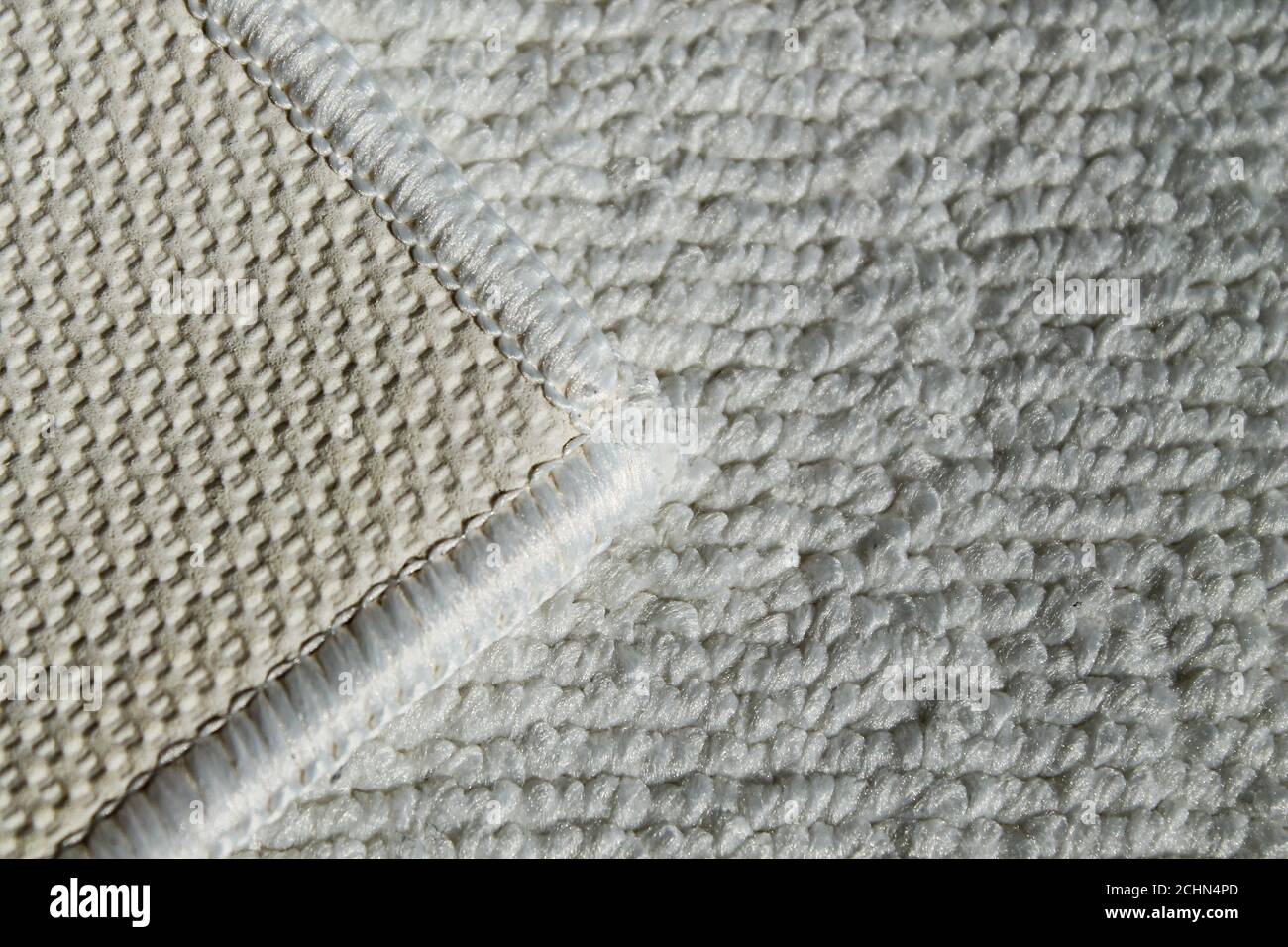 White rug for bathroom and toilet. Carpet texture with white overlock